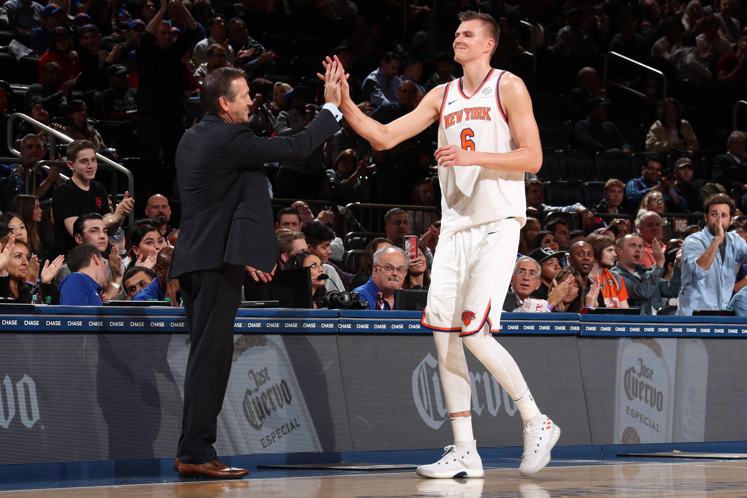 NEW YORK, NY - NOVEMBER 3:  Kristaps Porzingis #6 and Jeff Hornacek of the New York Knicks high five during the game against the Phoenix Suns on November 3, 2017 at Madison Square Garden in New York City, New York.  NOTE TO USER: User expressly acknowledg
