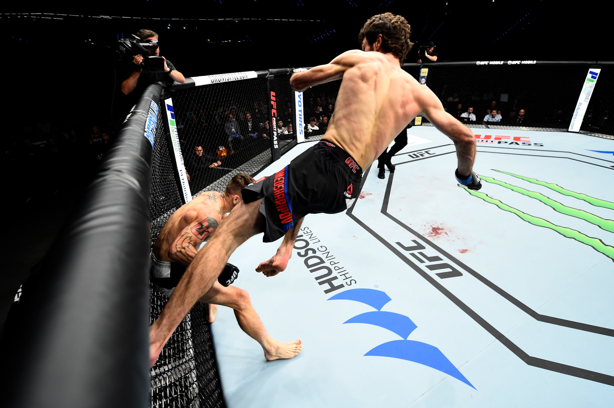 ROTTERDAM, NETHERLANDS - SEPTEMBER 02:  (R-L) Zabit Magomedsharipov of Russia jumps off the wall of the Octagon to kick Mike Santiago in their featherweight bout during the UFC Fight Night event at the Rotterdam Ahoy on September 2, 2017 in Rotterdam, Net