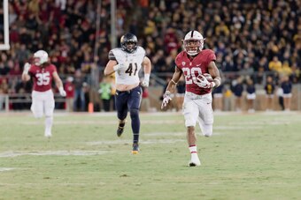 PALO ALTO, CA - NOVEMBER 18:  Bryce Love #20 of the Stanford Cardinal runs 57 yards for a touchdown during the annual Big Game against the California Golden Bears played November 18, 2017 at Stanford Stadium in Palo Alto, California.  Visible in backgroun