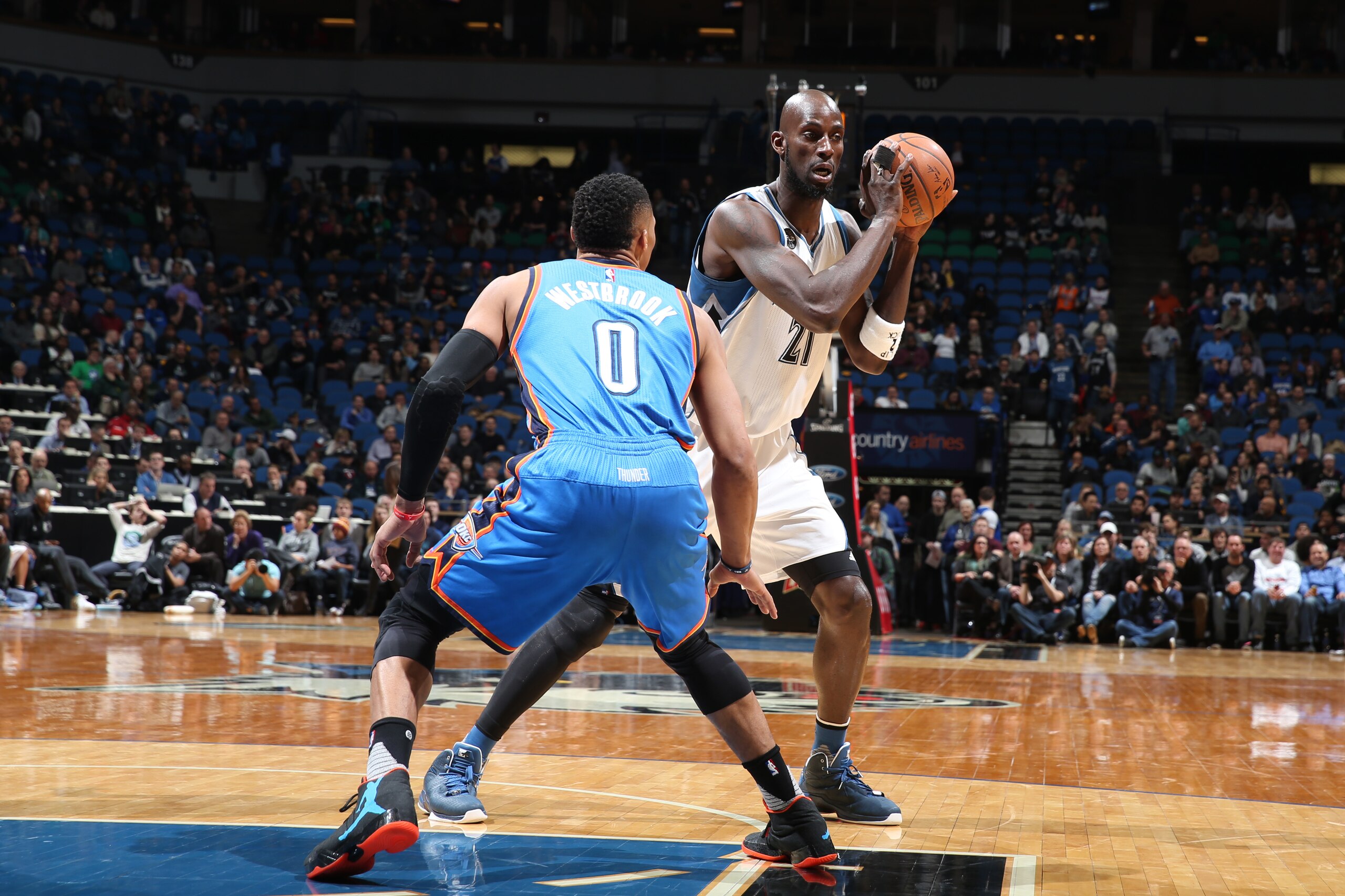 MINNEAPOLIS, MN -  JANUARY 12:  Kevin Garnett #21 of the Minnesota Timberwolves handles the ball against Russell Westbrook #0 of the Oklahoma City Thunder on January 12, 2016 at Target Center in Minneapolis, Minnesota. NOTE TO USER: User expressly acknowl