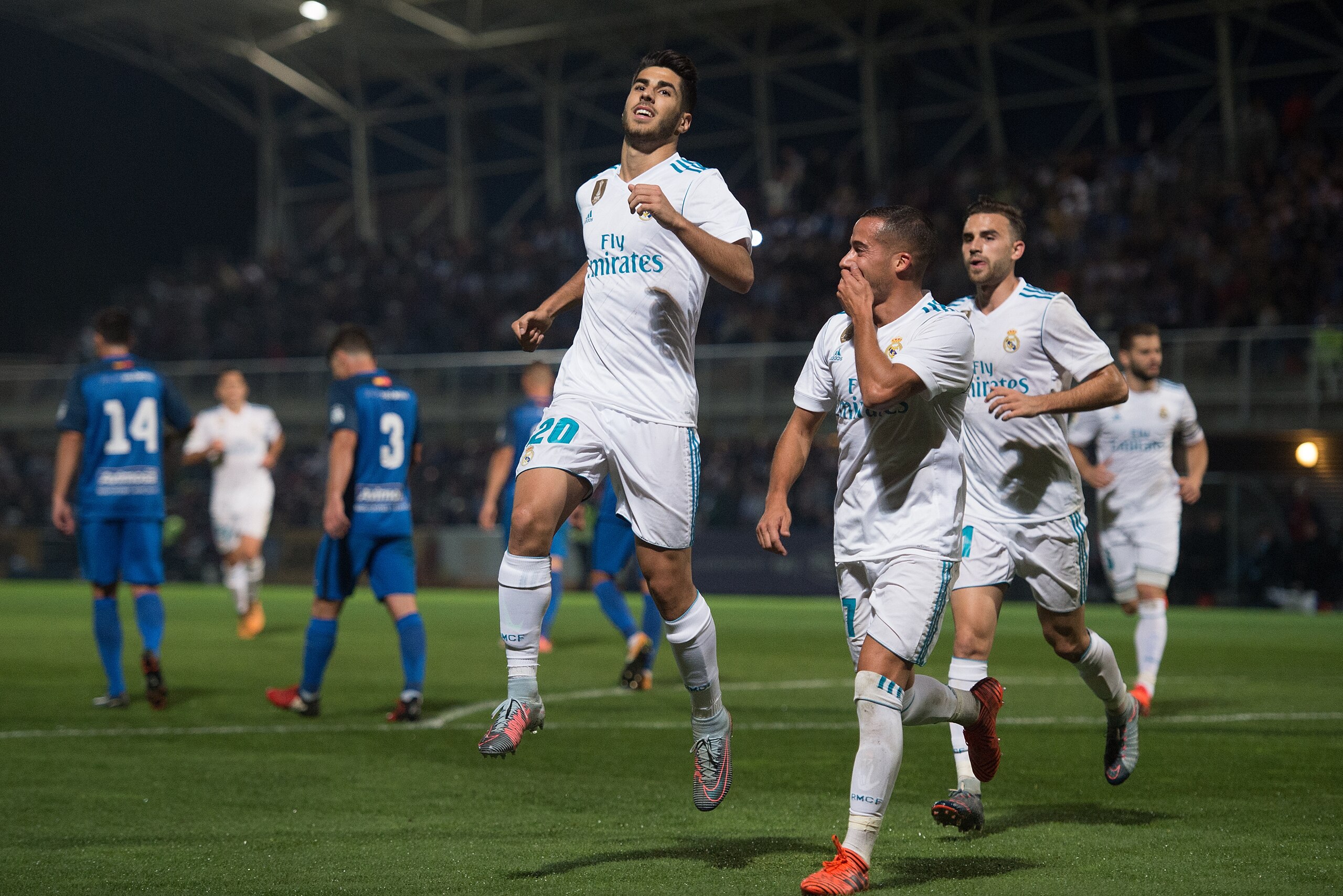 MADRID, SPAIN - OCTOBER 26: Marco Asensio of Real Madrid CF celebrates with teammates after scoring his teamÕs opening goal from a penalty kick during the Copa del Rey, Round of 32, First Leg match between Fuenlabrada and Real Madrid at Estadio Fernando T