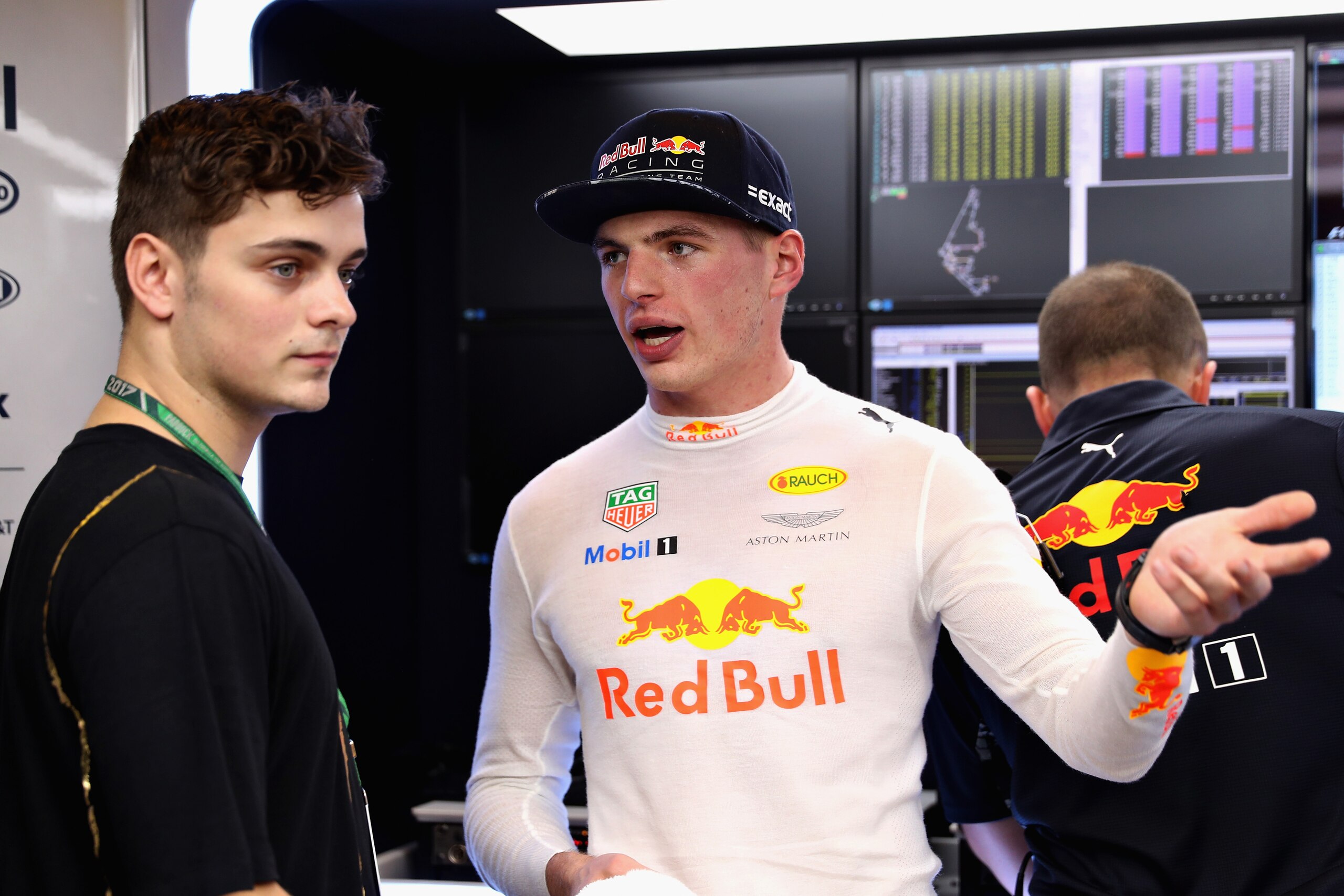ABU DHABI, UNITED ARAB EMIRATES - NOVEMBER 24:  Max Verstappen of Netherlands and Red Bull Racing talks with superstar DJ Martin Garrix in the Red Bull Racing garage after practice for the Abu Dhabi Formula One Grand Prix at Yas Marina Circuit on November
