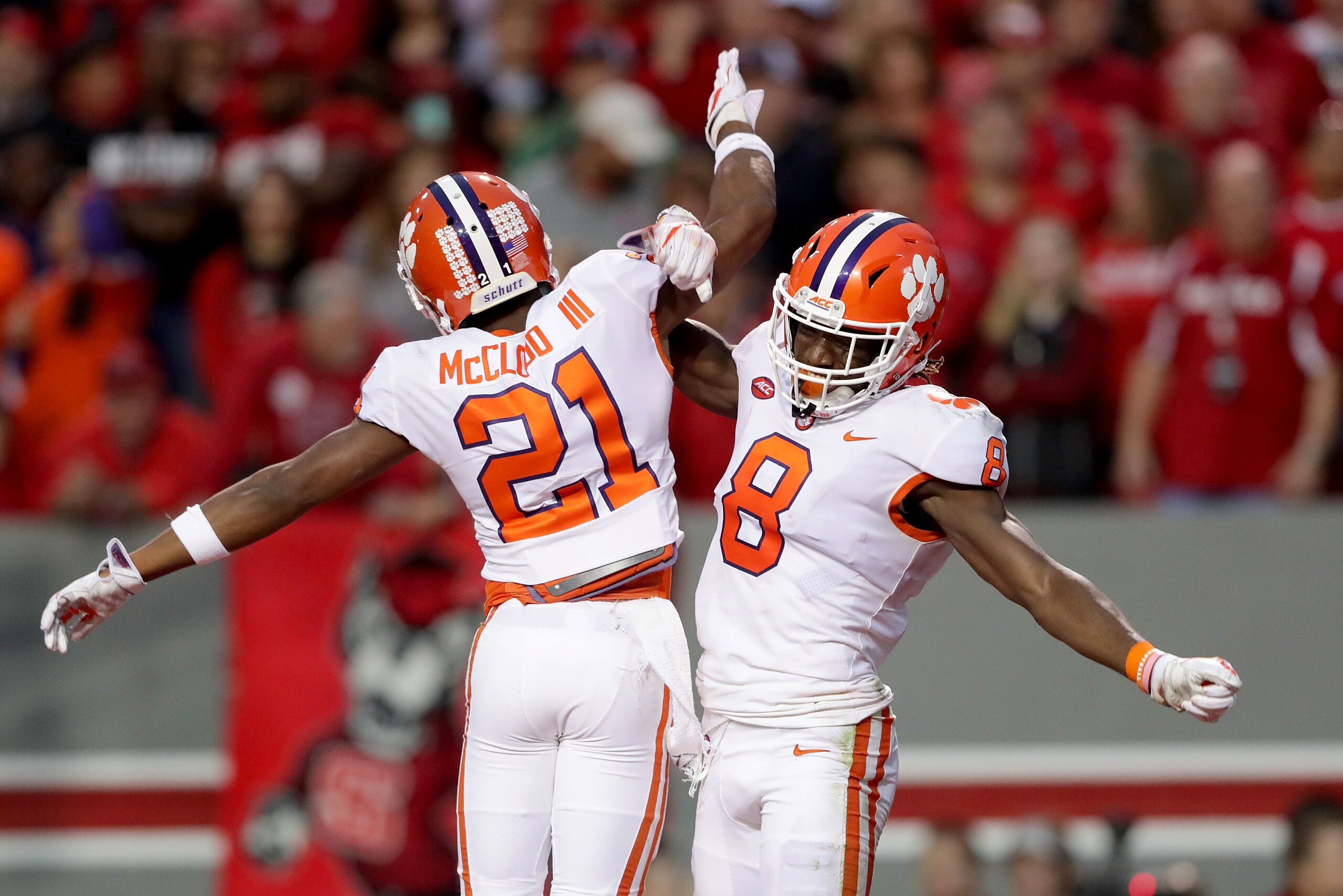 RALEIGH, NC - NOVEMBER 04:  Deon Cain #8 celebrates after scoring a touchdown with teammate Ray-Ray McCloud #21 of the Clemson Tigers during their game against the North Carolina State Wolfpack at Carter Finley Stadium on November 4, 2017 in Raleigh, Nort