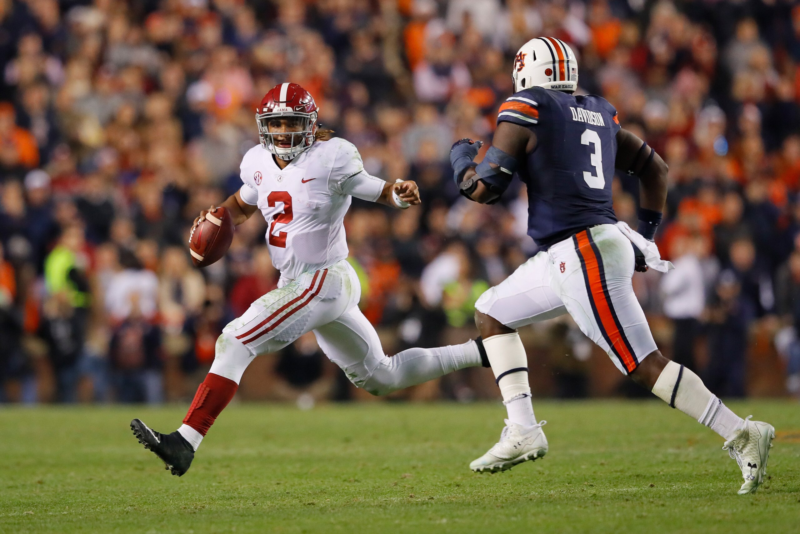 AUBURN, AL - NOVEMBER 25:  Jalen Hurts #2 of the Alabama Crimson Tide is pursued by Marlon Davidson #3 of the Auburn Tigers during the fourth quarter of the game at Jordan Hare Stadium on November 25, 2017 in Auburn, Alabama.  (Photo by Kevin C. Cox/Getty