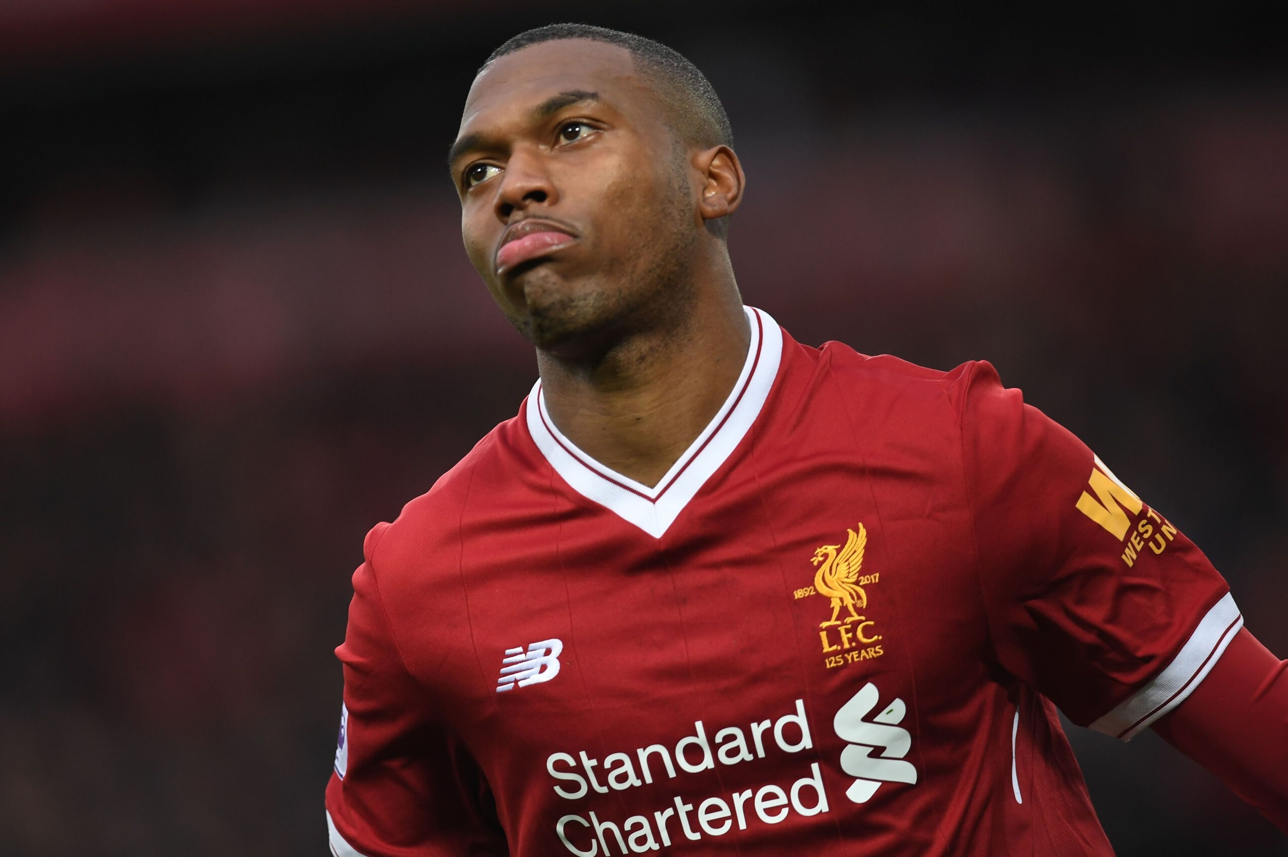 Liverpool's English striker Daniel Sturridge celebrates after scoring the opening goal of the English Premier League football match between Liverpool and Huddersfield Town at Anfield in Liverpool, north west England on October 28, 2017. / AFP PHOTO / Paul