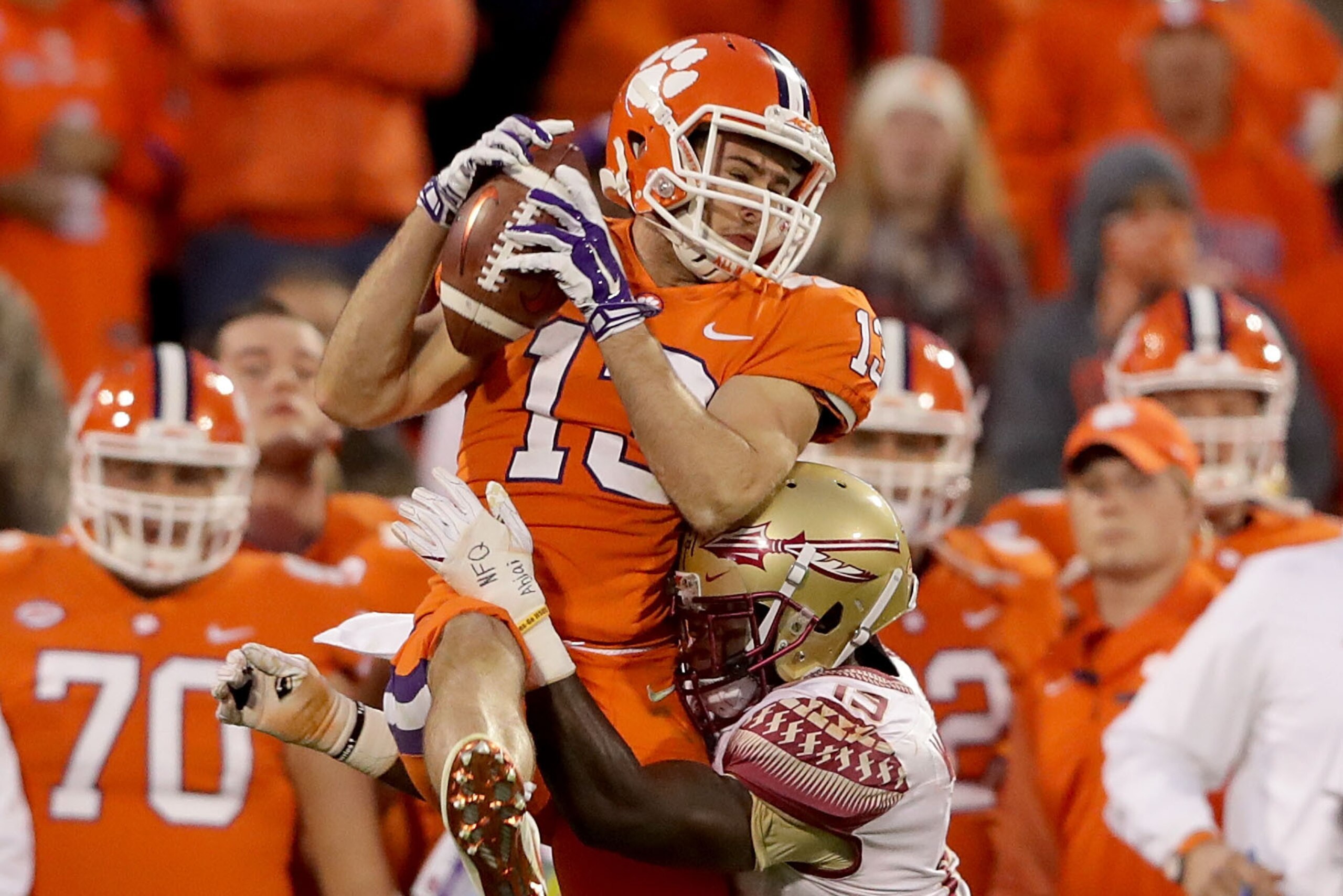 CLEMSON, SC - NOVEMBER 11:  Hunter Renfrow #13 of the Clemson Tigers makes a catch over A.J. Westbrook #19 of the Florida State Seminoles during their game at Memorial Stadium on November 11, 2017 in Clemson, South Carolina.  (Photo by Streeter Lecka/Gett