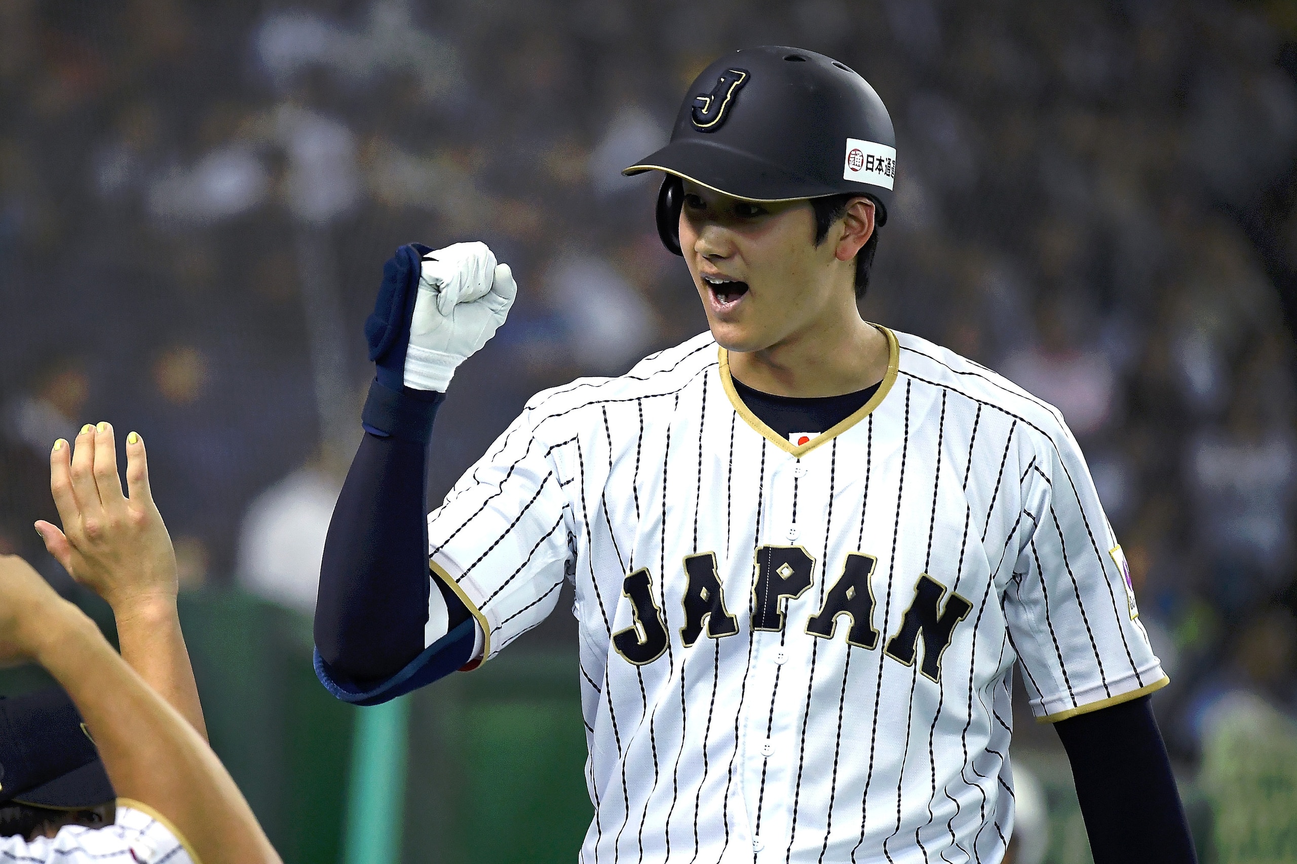 TOKYO, JAPAN - NOVEMBER 12:  Shohei Ohtani #16 of Japan celebrates after hitting a solo homer in the fifth inning during the international friendly match between Japan and Netherlands at the Tokyo Dome on November 12, 2016 in Tokyo, Japan.  (Photo by Mast