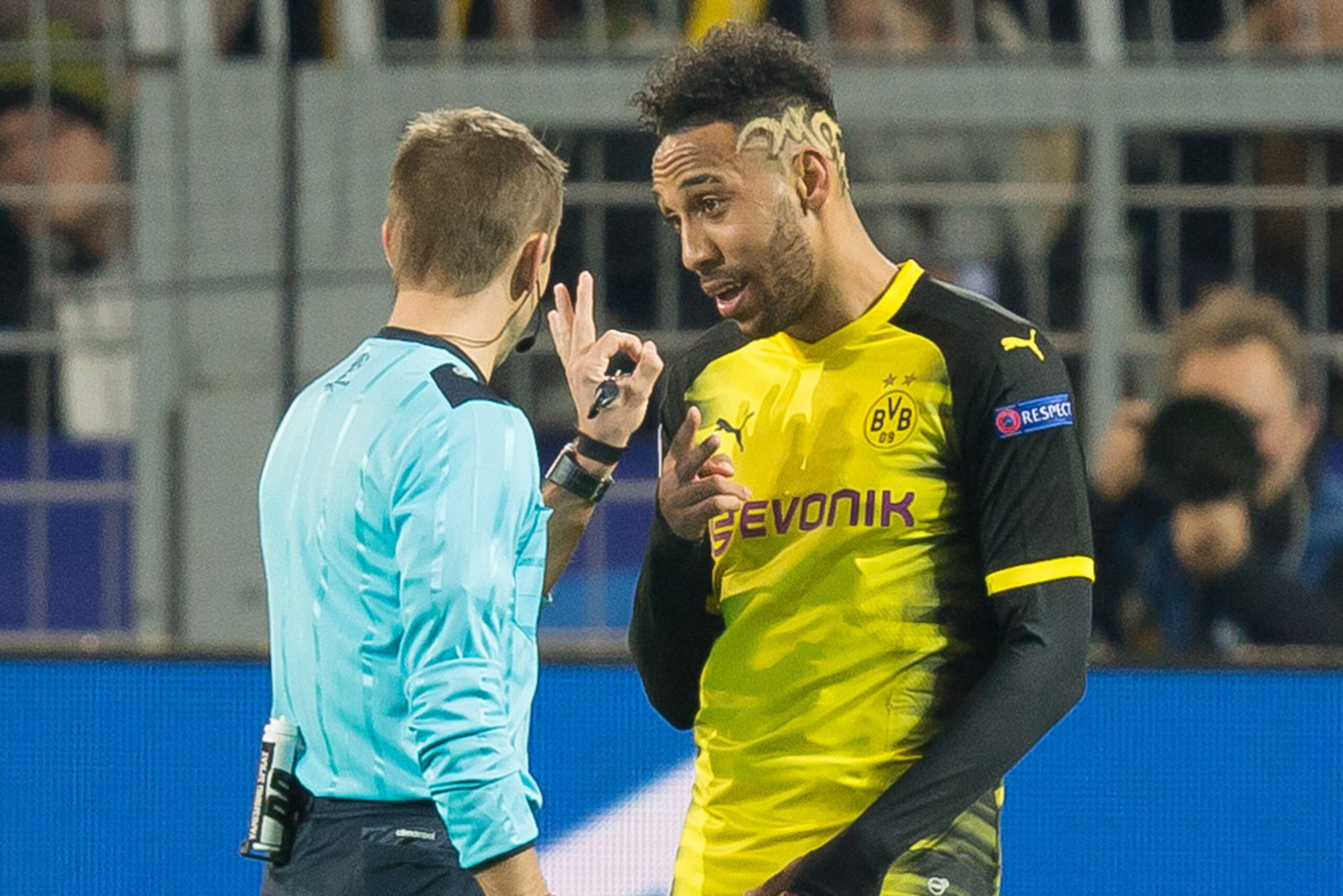 DORTMUND, GERMANY - NOVEMBER 21: Referee Clement Turpin speaks with Auba, Pierre-Emerick Aubameyang of Borussia Dortmund during the UEFA Champions League group H match between Borussia Dortmund and Tottenham Hotspur at Signal Iduna Park on November 21, 20
