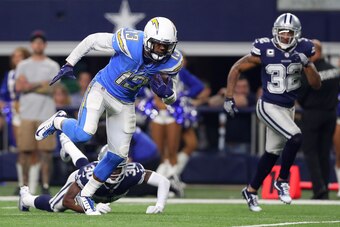 ARLINGTON, TX - NOVEMBER 23:  Keenan Allen #13 of the Los Angeles Chargers breaks tackle by Anthony Brown #30 of the Dallas Cowboys on a touchdown run in the fourth quarter at AT&T Stadium on November 23, 2017 in Arlington, Texas.  (Photo by Tom Penningto