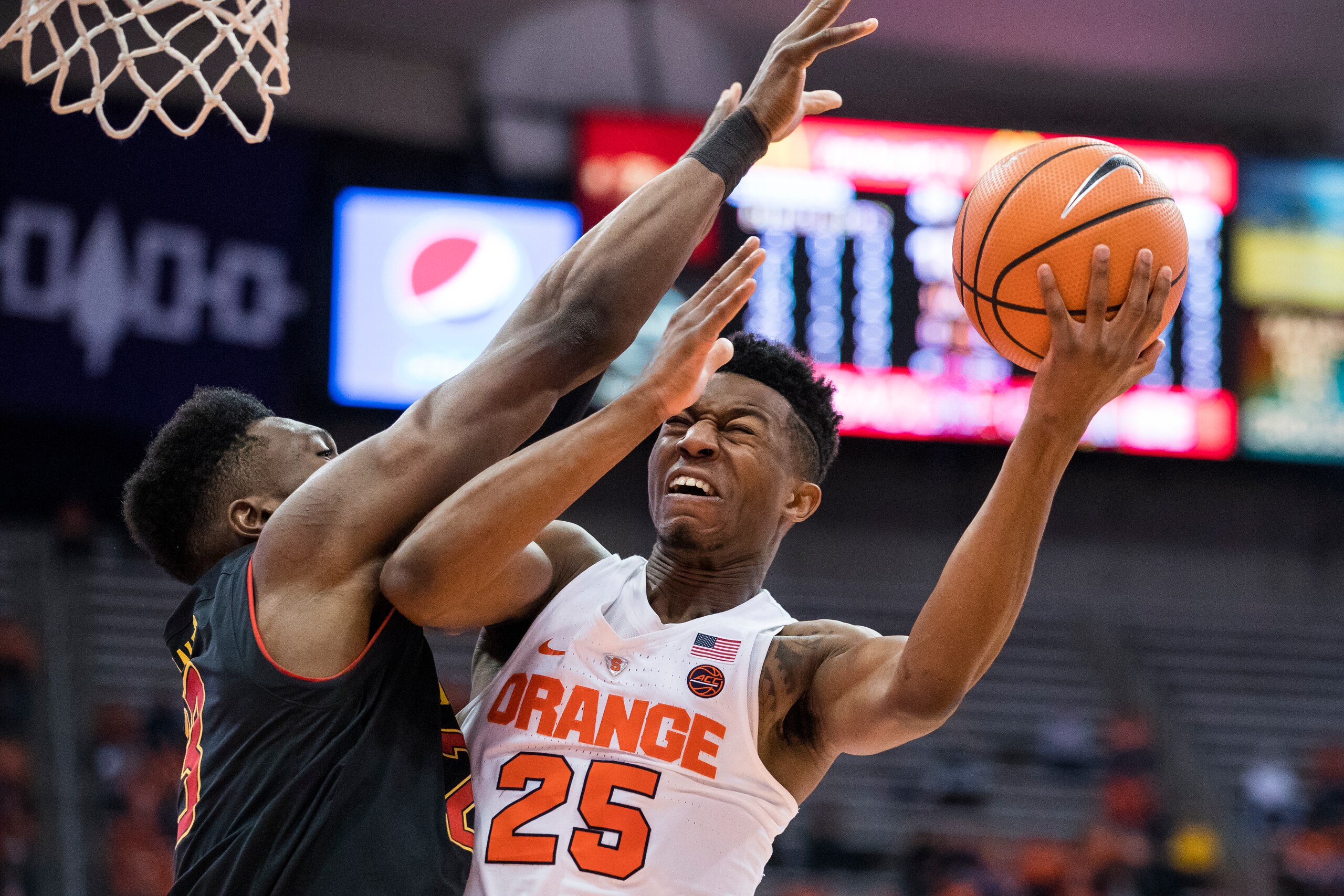 SYRACUSE, NY - NOVEMBER 27:  Bruno Fernando #23 of the Maryland Terrapins defends as Tyus Battle #25 of the Syracuse Orange drives to the basket for a lay up during the second half at the Carrier Dome on November 27, 2017 in Syracuse, New York. Syracuse d