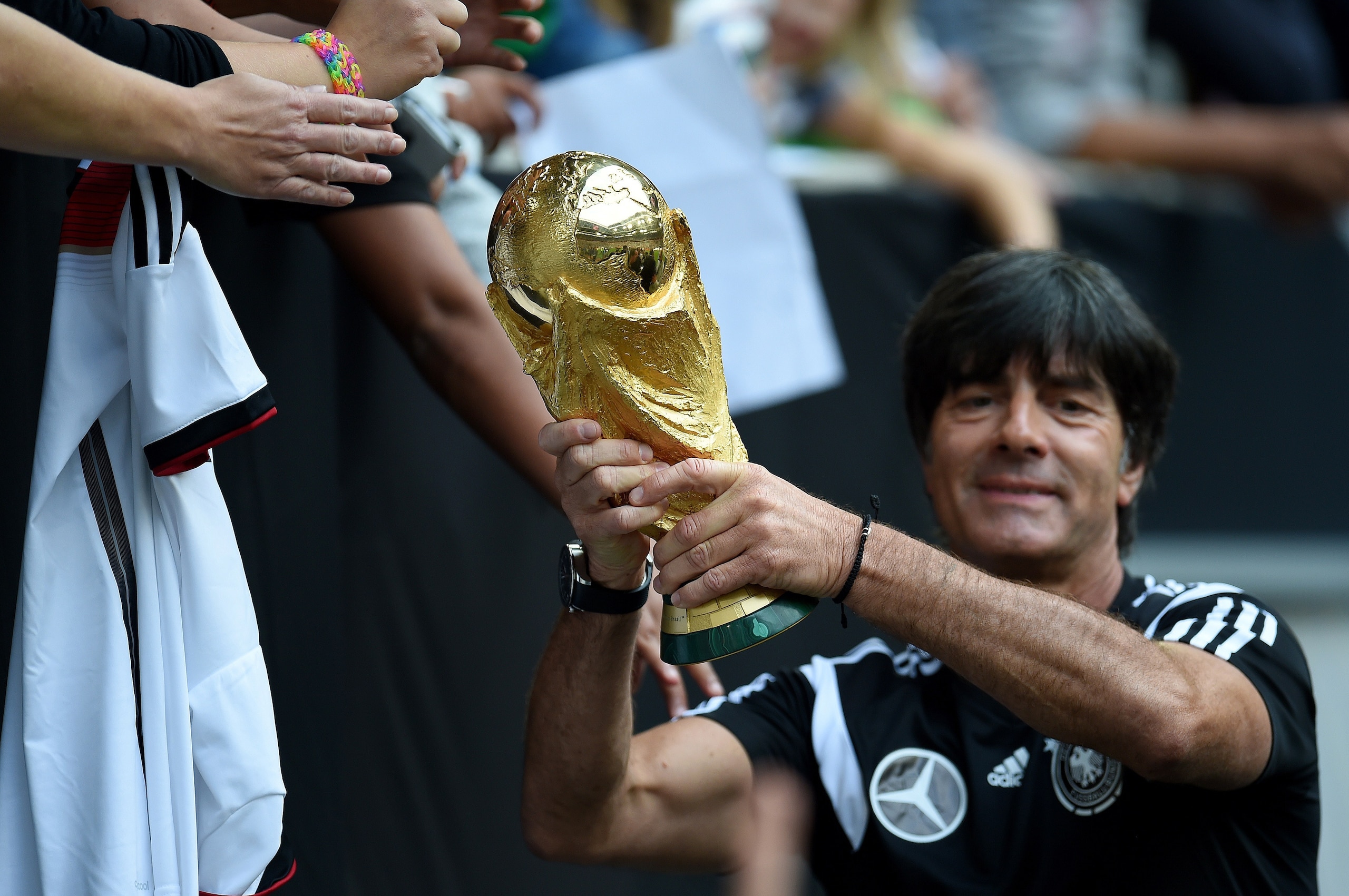 Germany's head coach Joachim Loew shows the world cup trophy during a public training session of the German national football team in Duesseldorf, Germany on September 1, 2014. Germany's squad prepares for the upcoming friendly game against Argentina on S Germany's head coach Joachim Loew shows the world cup trophy during a public training session of the German national football team in Duesseldorf, Germany on September 1, 2014. Germany's squad prepares for the upcoming friendly game against Argentina on S