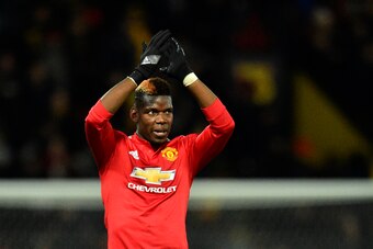 Manchester United's French midfielder Paul Pogba applauds at the end of the English Premier League football match between Watford and Manchester United at Vicarage Road Stadium in Watford, north of London on November 28, 2017. / AFP PHOTO / Glyn KIRK / RE
