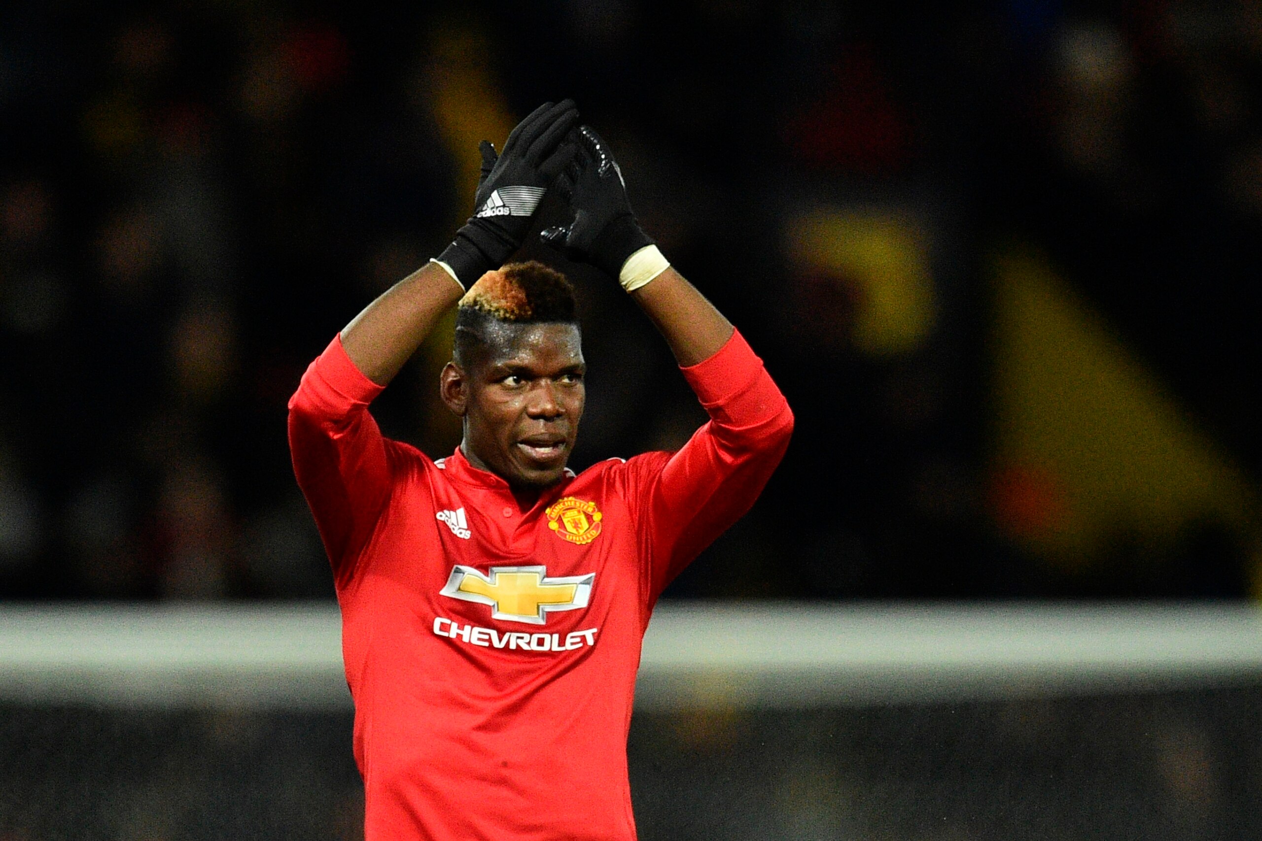 Manchester United's French midfielder Paul Pogba applauds at the end of the English Premier League football match between Watford and Manchester United at Vicarage Road Stadium in Watford, north of London on November 28, 2017. / AFP PHOTO / Glyn KIRK / RE