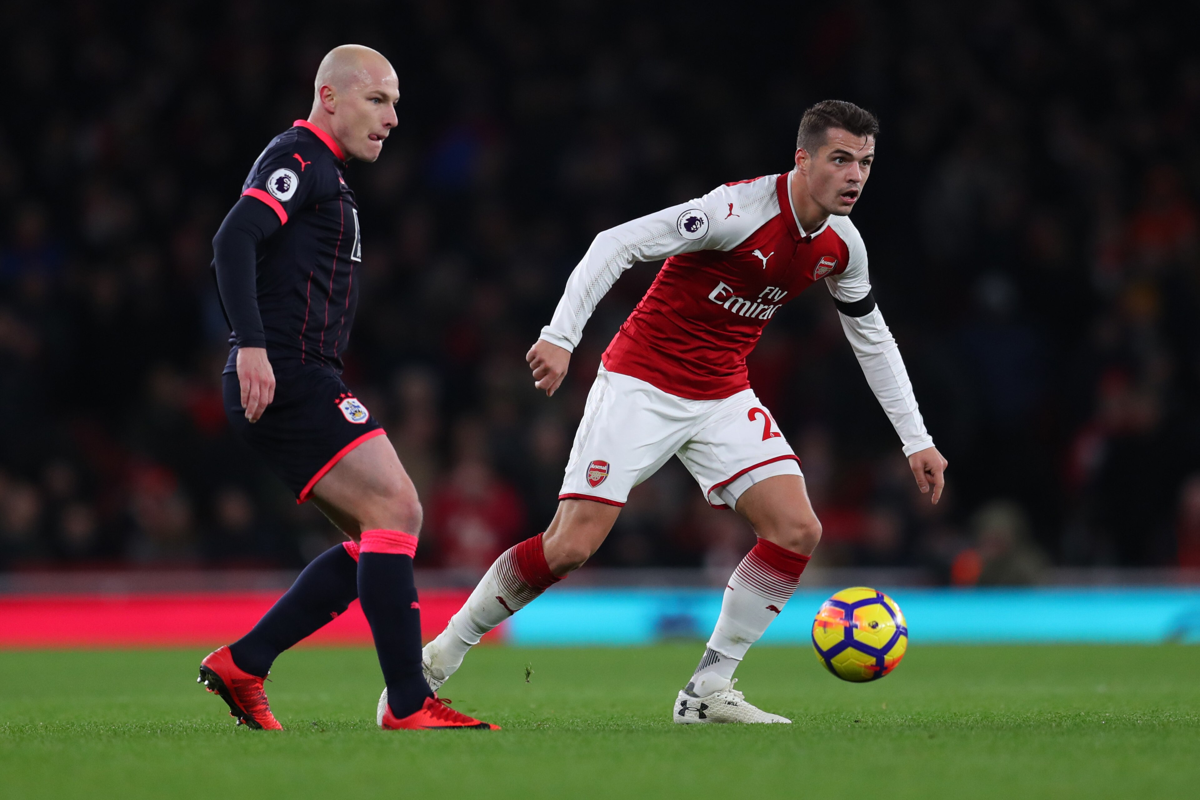 LONDON, ENGLAND - NOVEMBER 29: Aaron Mooy of Huddersfield Town and Granit Xhaka of Arsenal during the Premier League match between Arsenal and Huddersfield Town at Emirates Stadium on November 29, 2017 in London, England. (Photo by Catherine Ivill/Getty I