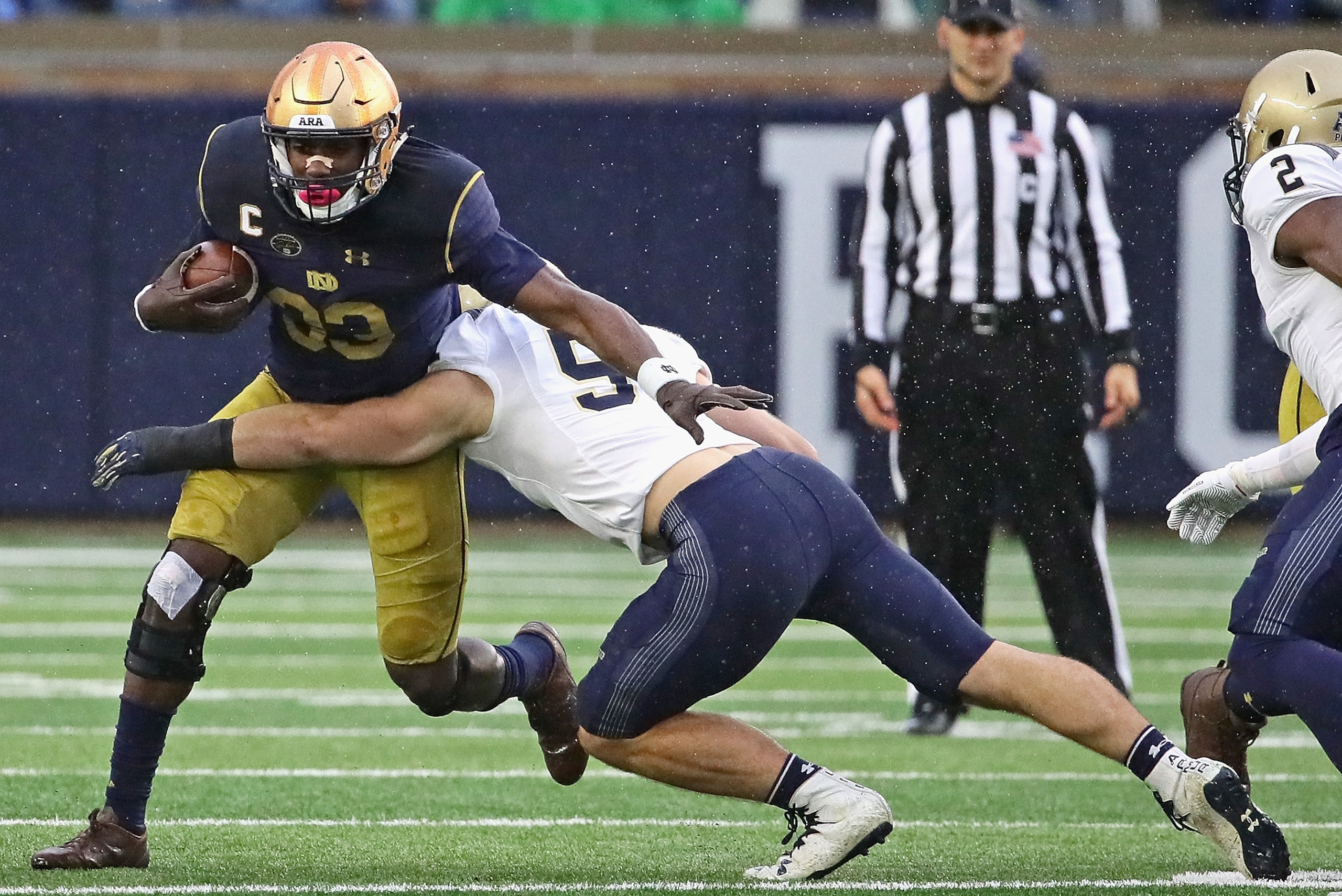 SOUTH BEND, IN - NOVEMBER 18: Josh Adams #33 of the Notre Dame Fighting Irish gets around Winn Howard #51 of the Navy Midshipmen at Notre Dame Stadium on November 18, 2017 in South Bend, Indiana. (Photo by Jonathan Daniel/Getty Images) SOUTH BEND, IN - NOVEMBER 18: Josh Adams #33 of the Notre Dame Fighting Irish gets around Winn Howard #51 of the Navy Midshipmen at Notre Dame Stadium on November 18, 2017 in South Bend, Indiana. (Photo by Jonathan Daniel/Getty Images)
