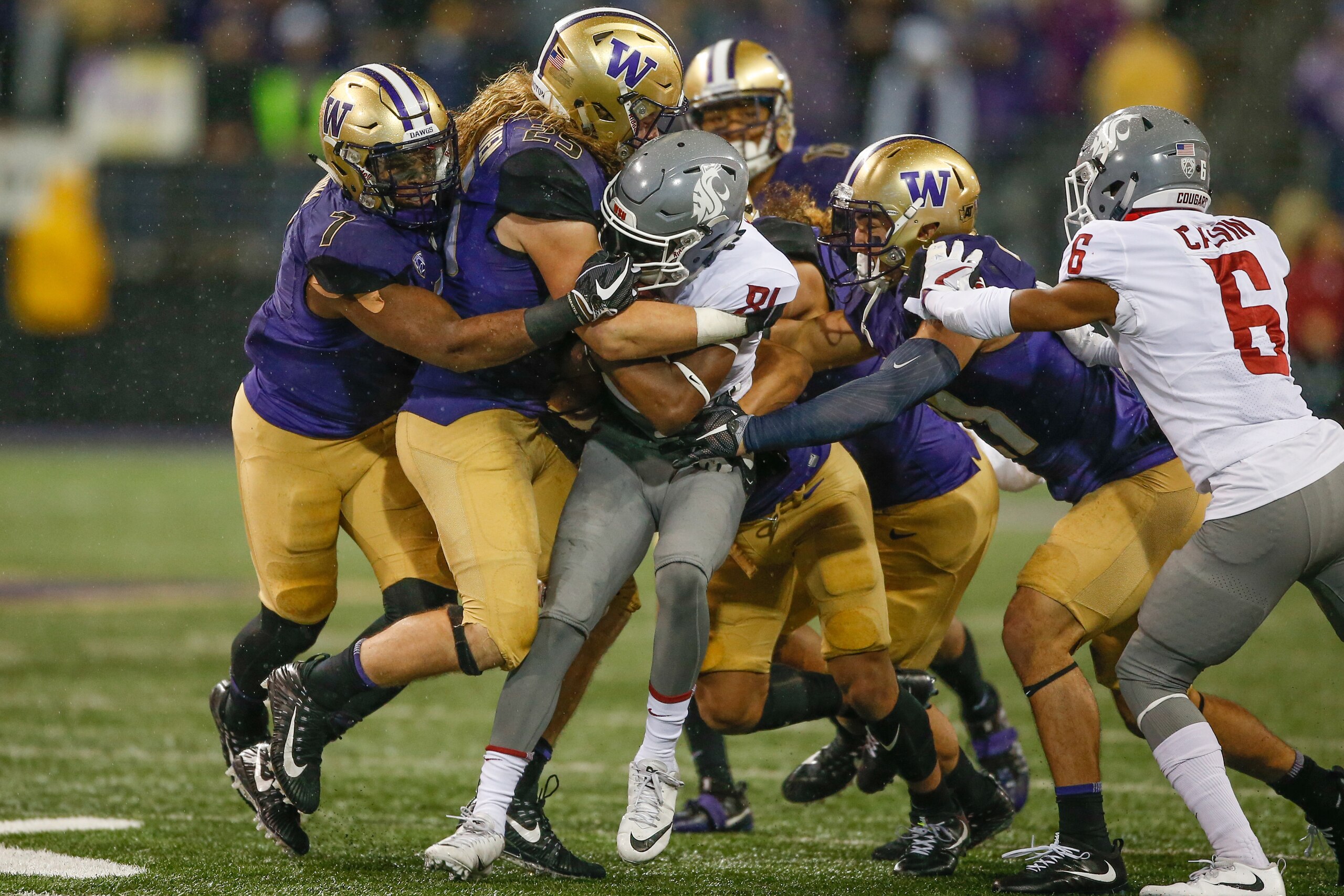 SEATTLE, WA - NOVEMBER 25: Wide receiver Renard Bell #81 of the Washington State Cougars is tackled by linebacker Ben Burr-Kirven #25 of the Washington Huskies at Husky Stadium on November 25, 2017 in Seattle, Washington. (Photo by Otto Greule Jr/Getty SEATTLE, WA - NOVEMBER 25: Wide receiver Renard Bell #81 of the Washington State Cougars is tackled by linebacker Ben Burr-Kirven #25 of the Washington Huskies at Husky Stadium on November 25, 2017 in Seattle, Washington. (Photo by Otto Greule Jr/Getty