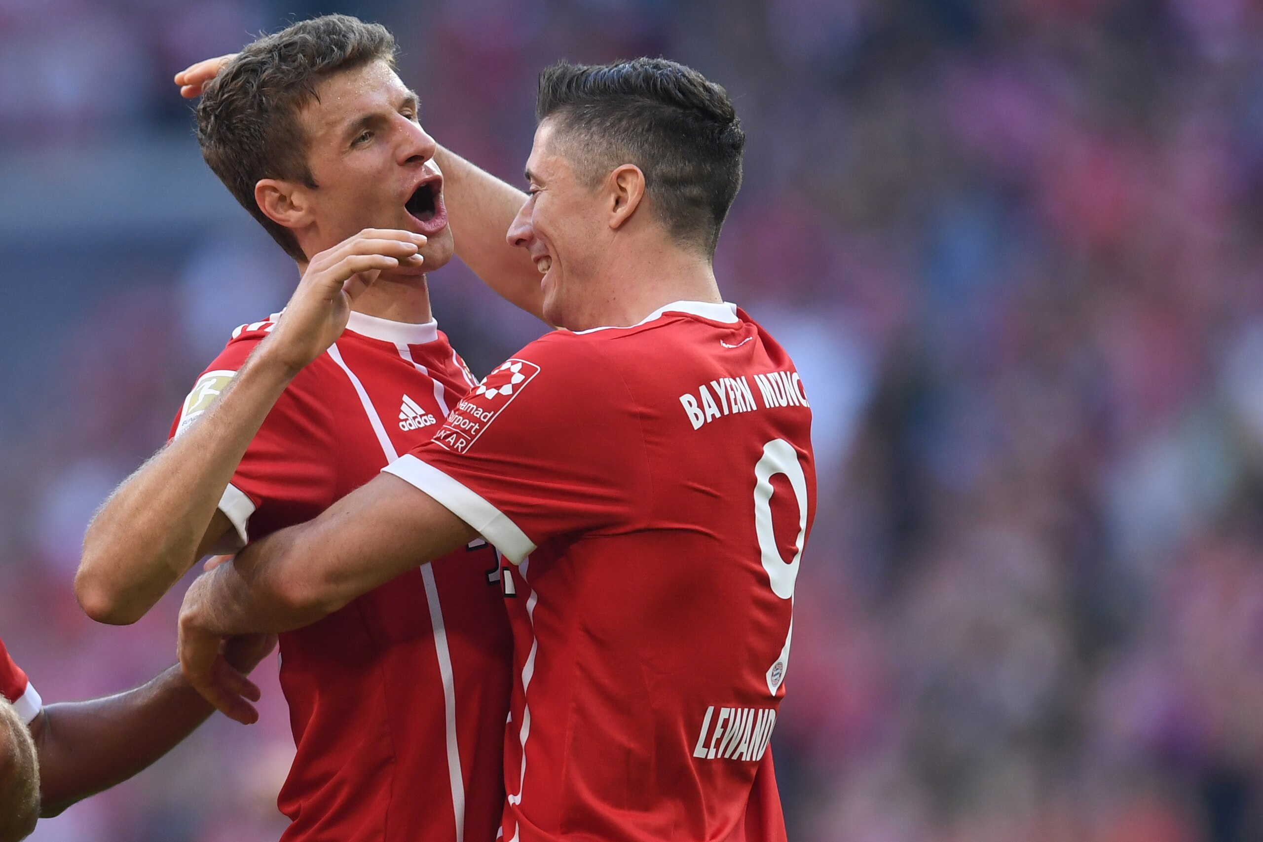 Bayern Munich's striker Thomas Mueller (L) and Bayern Munich's Polish striker Robert Lewandowski (R) celebrate after Lewandowski scored 4:0 during the German First division Bundesliga football match FC Bayern Munich vs SC Freiburg in Munich, southern Germ