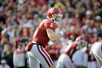 NORMAN, OK - NOVEMBER 25: Quarterback Baker Mayfield #6 of the Oklahoma Sooners prepares to take a snap against the West Virginia Mountaineers at Gaylord Family Oklahoma Memorial Stadium on November 25, 2017 in Norman, Oklahoma. Oklahoma defeated West Vir