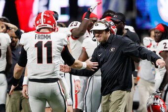 ATLANTA, GA - DECEMBER 02: Head coach Kirby Smart of the Georgia Bulldogs celebrates with Jake Fromm #11 after a touchdown during the second half against the Auburn Tigers in the SEC Championship at Mercedes-Benz Stadium on December 2, 2017 in Atlanta, Ge