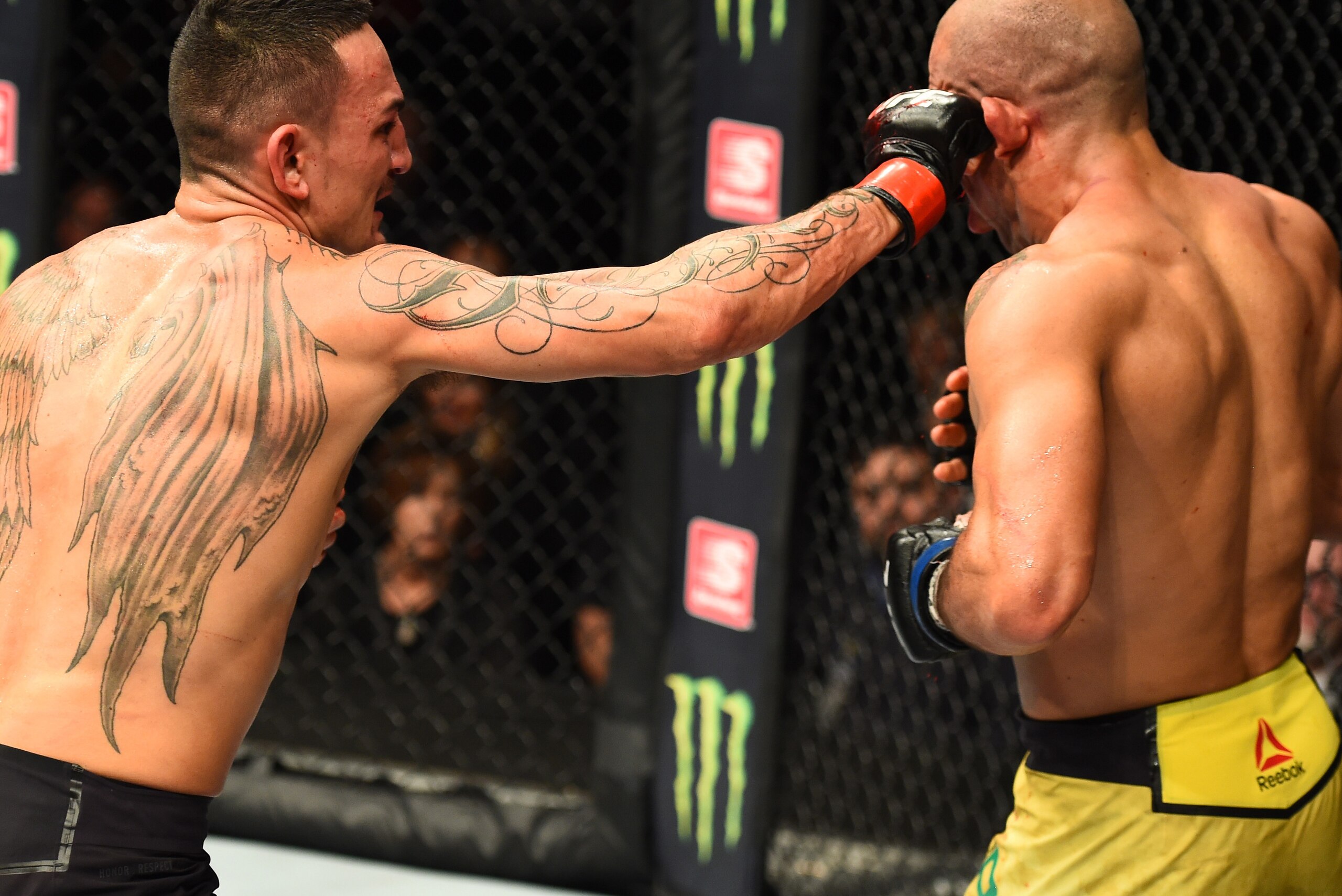 DETROIT, MI - DECEMBER 02:  (L-R) Max Holloway punches Jose Aldo of Brazil in their UFC featherweight championship bout during the UFC 218 event inside Little Caesars Arena on December 02, 2017 in Detroit, Michigan. (Photo by Josh Hedges/Zuffa LLC/Zuffa L