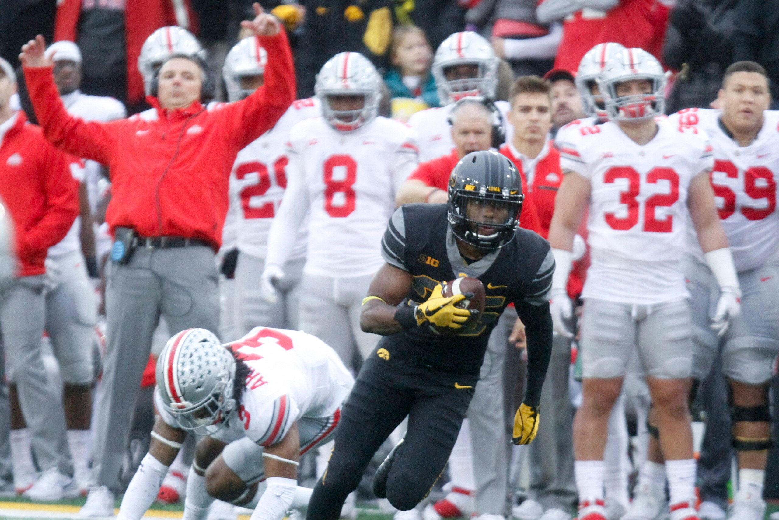 IOWA CITY, IOWA- NOVEMBER 04:  Running back Akrum Wadley #25 of the Iowa Hawkeyes breaks a tackle during the second quarter by cornerback Damon Arnette #3 of the Ohio State Buckeyes on November 04, 2017 at Kinnick Stadium in Iowa City, Iowa.  (Photo by Ma