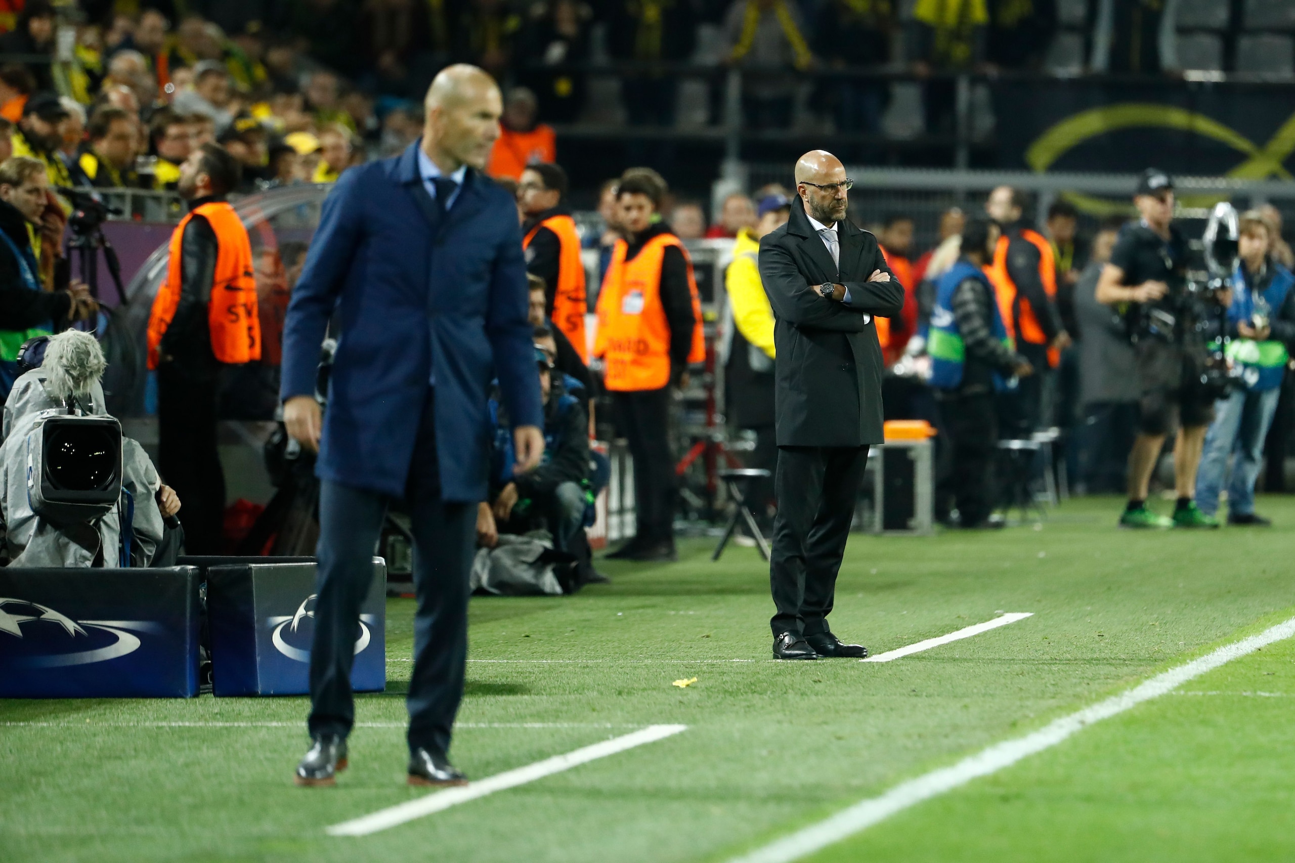 Dortmund's Dutch head coach Peter Bosz and Real Madrid's coach from France Zinedine Zidane (L) follow the action from the sidelines during the UEFA Champions League Group H football match BVB Borussia Dortmund v Real Madrid in Dortmund, western Germany on Dortmund's Dutch head coach Peter Bosz and Real Madrid's coach from France Zinedine Zidane (L) follow the action from the sidelines during the UEFA Champions League Group H football match BVB Borussia Dortmund v Real Madrid in Dortmund, western Germany on
