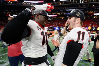 ATLANTA, GA - DECEMBER 02: Jake Fromm #11 celebrates with Malik Herring #10 of the Georgia Bulldogs after beating the Auburn Tigers in the SEC Championship at Mercedes-Benz Stadium on December 2, 2017 in Atlanta, Georgia. (Photo by Kevin C.  Cox/Getty Ima