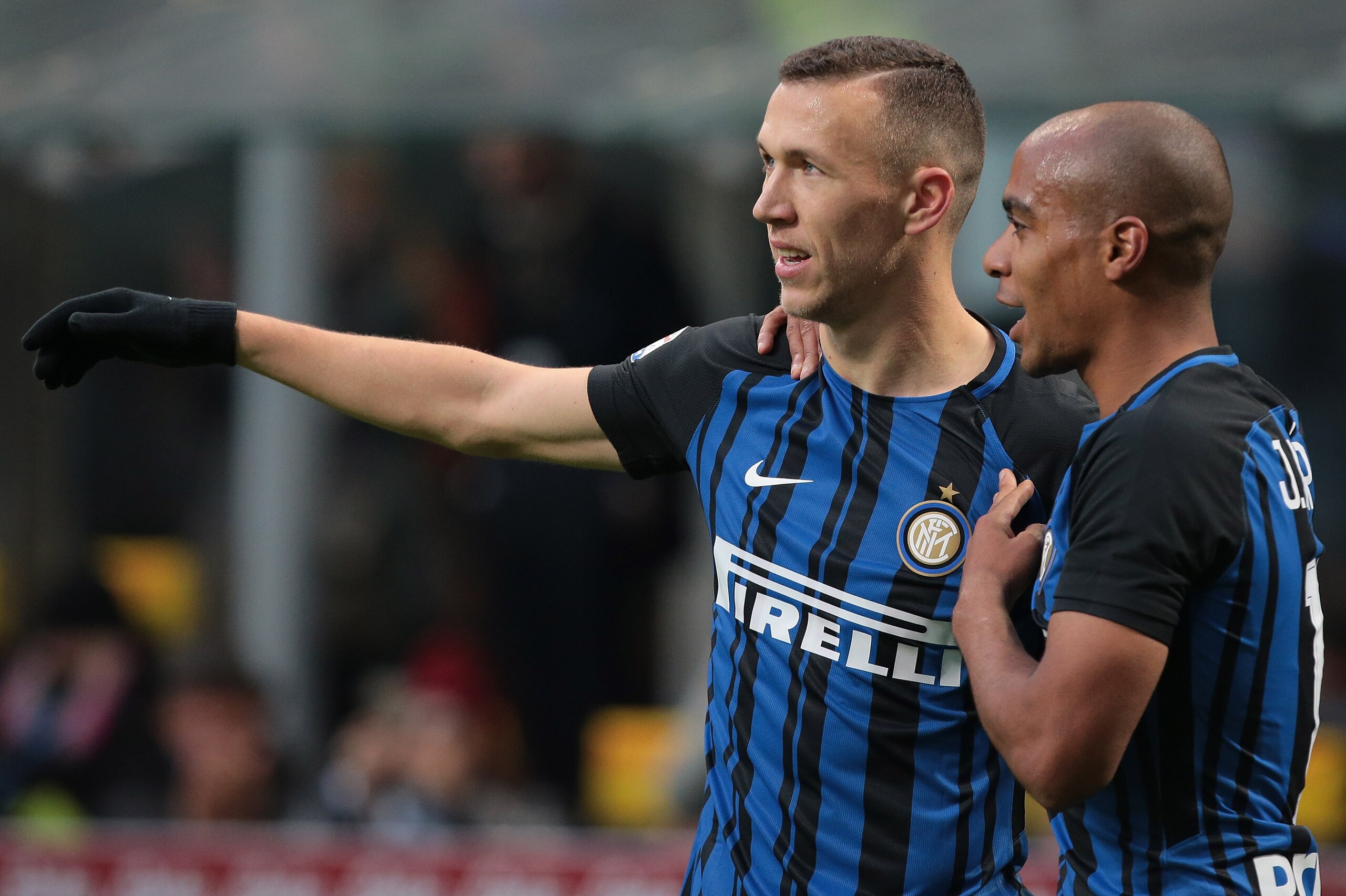 MILAN, ITALY - DECEMBER 03: Ivan Perisic of FC Internazionale Milano celebrates his second goal with his teammate Joao Mario (R) during the Serie A match between FC Internazionale and AC Chievo Verona at Stadio Giuseppe Meazza on December 3, 2017 in Mila MILAN, ITALY - DECEMBER 03: Ivan Perisic of FC Internazionale Milano celebrates his second goal with his teammate Joao Mario (R) during the Serie A match between FC Internazionale and AC Chievo Verona at Stadio Giuseppe Meazza on December 3, 2017 in Mila