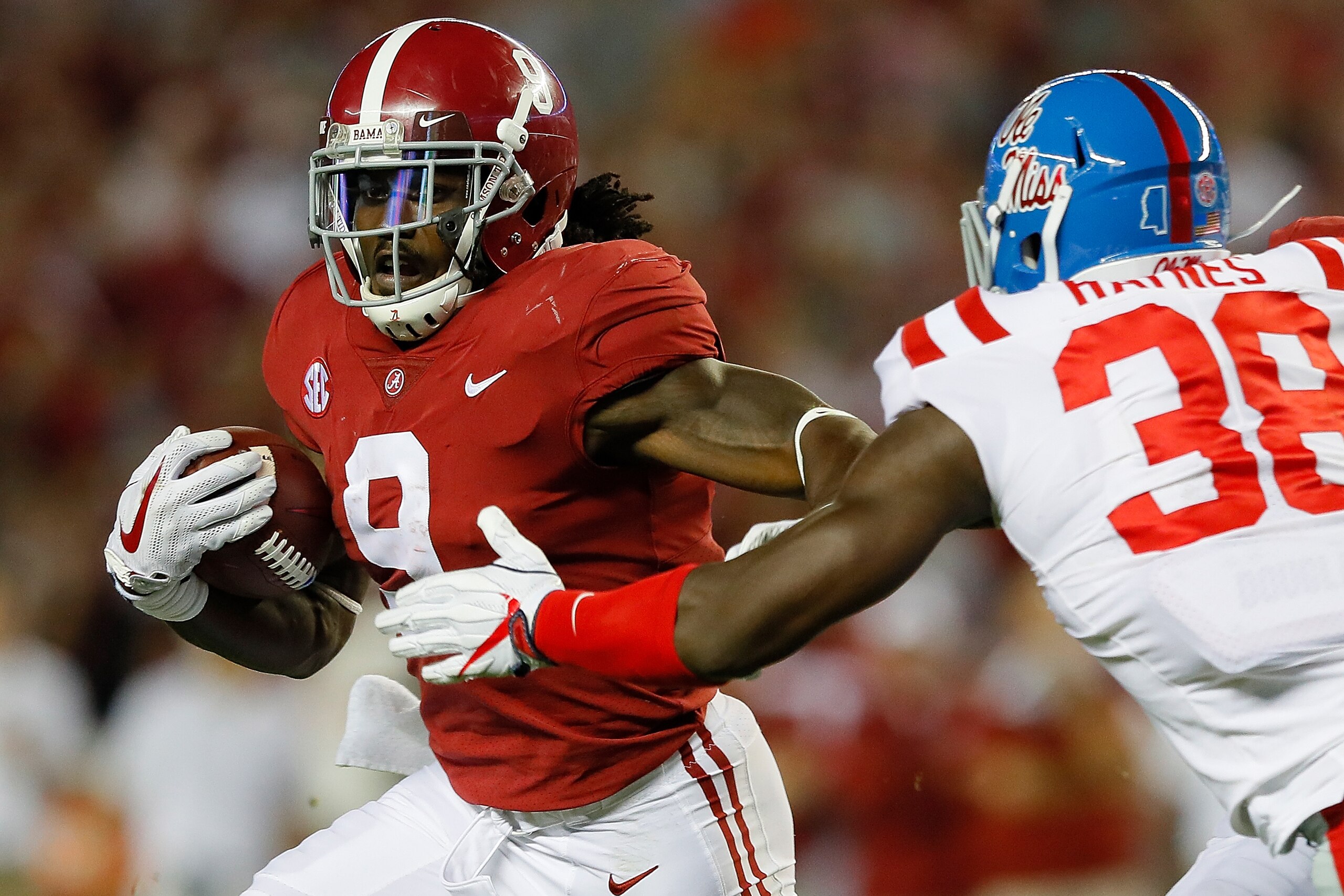 TUSCALOOSA, AL - SEPTEMBER 30:  Bo Scarbrough #9 of the Alabama Crimson Tide rushes away from Marquis Haynes #38 of the Mississippi Rebels at Bryant-Denny Stadium on September 30, 2017 in Tuscaloosa, Alabama.  (Photo by Kevin C. Cox/Getty Images)