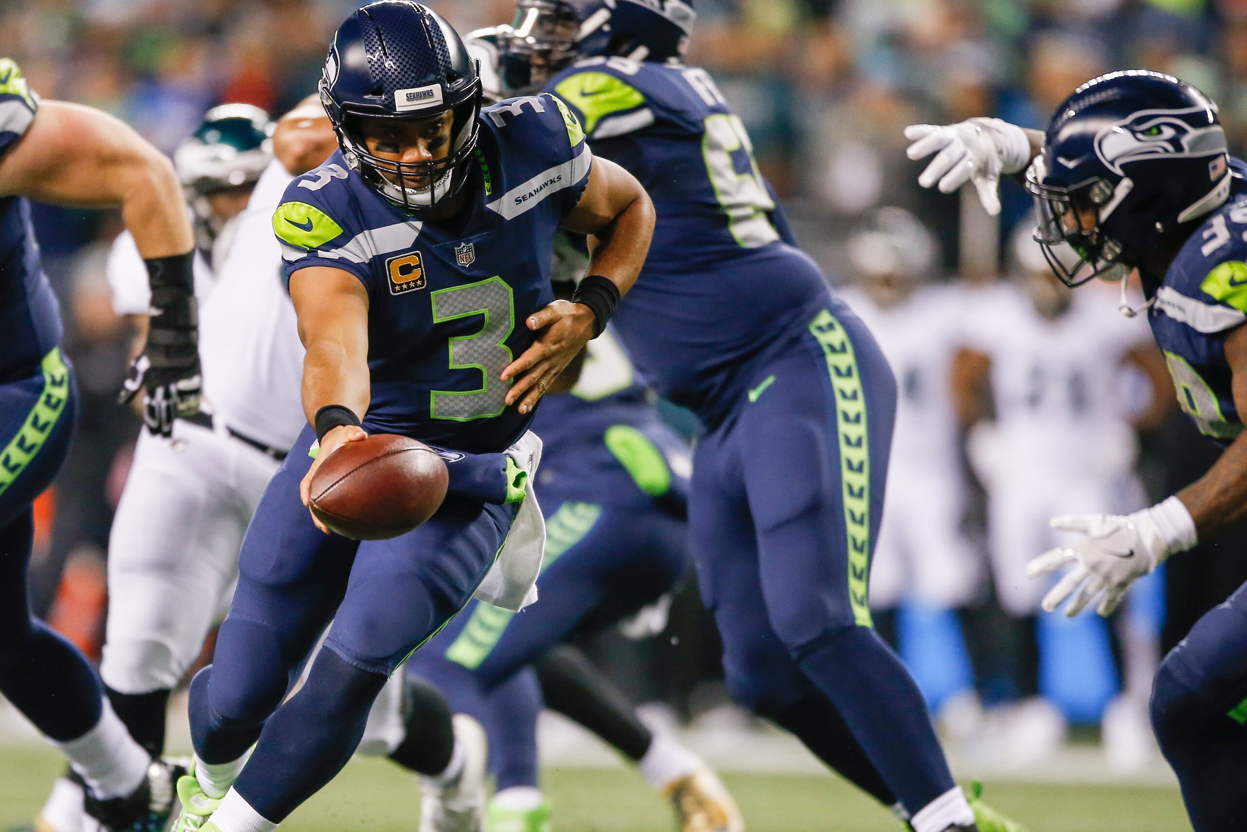 SEATTLE, WA - DECEMBER 03: Quarterback Russell Wilson #3 of the Seattle Seahawks hands off to Mike Davis #39 in the first half against the Philadelphia Eagles at CenturyLink Field on December 3, 2017 in Seattle, Washington. (Photo by Otto Greule Jr /Getty