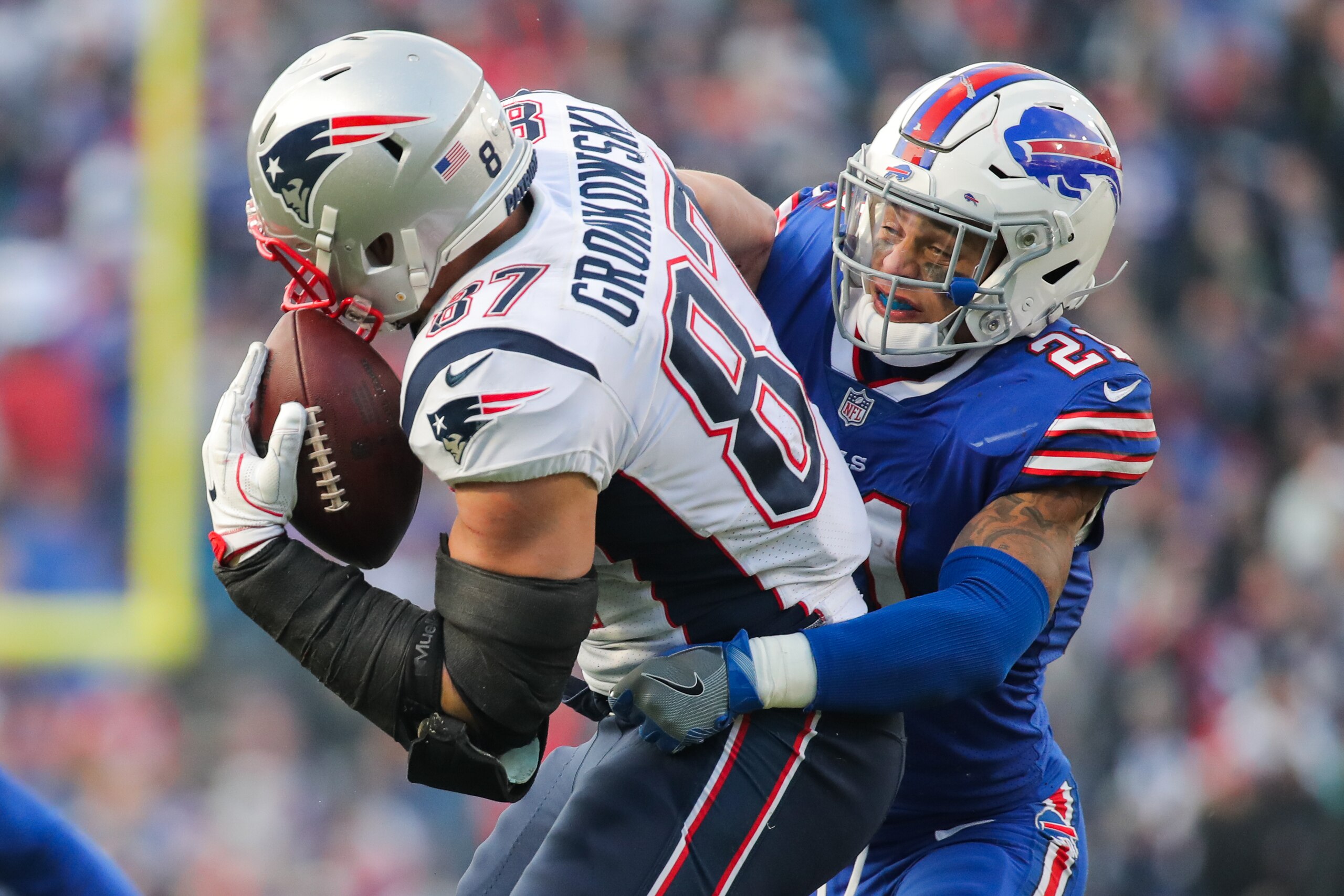 ORCHARD PARK, NY - DECEMBER 3:  Rob Gronkowski #87 of the New England Patriots holds the ball as Jordan Poyer #21 of the Buffalo Bills attempts to tackle him during the fourth quarter on December 3, 2017 at New Era Field in Orchard Park, New York.  (Photo