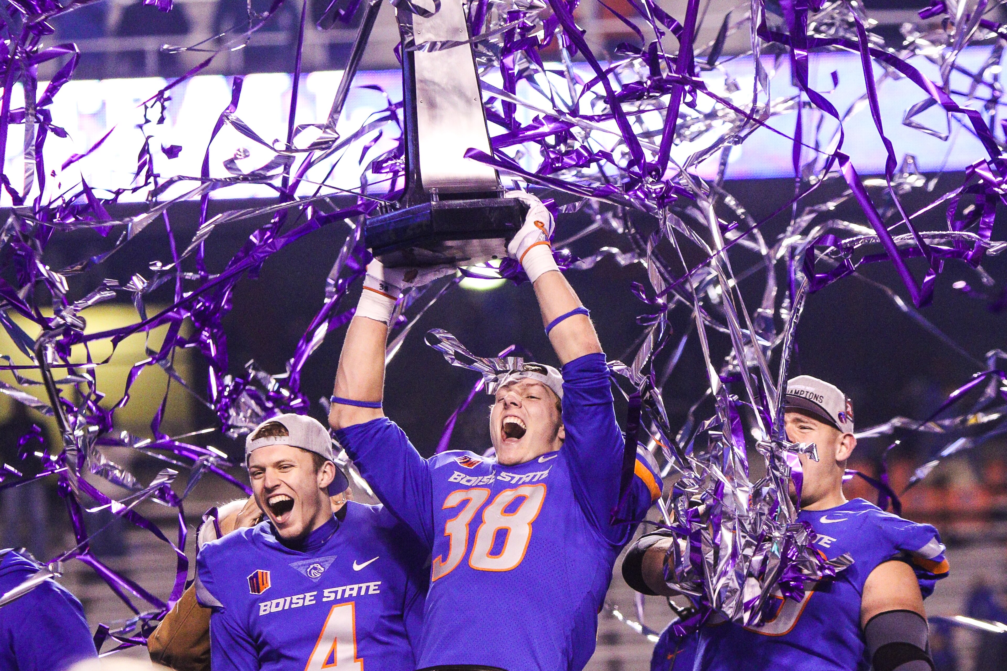 BOISE, ID - DECEMBER 2: Linebacker Leighton Vander Esch #38 and quarterback Brett Rypien #4 of the Boise State Broncos hoist the championship trophy at the conclusion of the Mountain West Championship game against the Fresno State Bulldogs on December 2, 