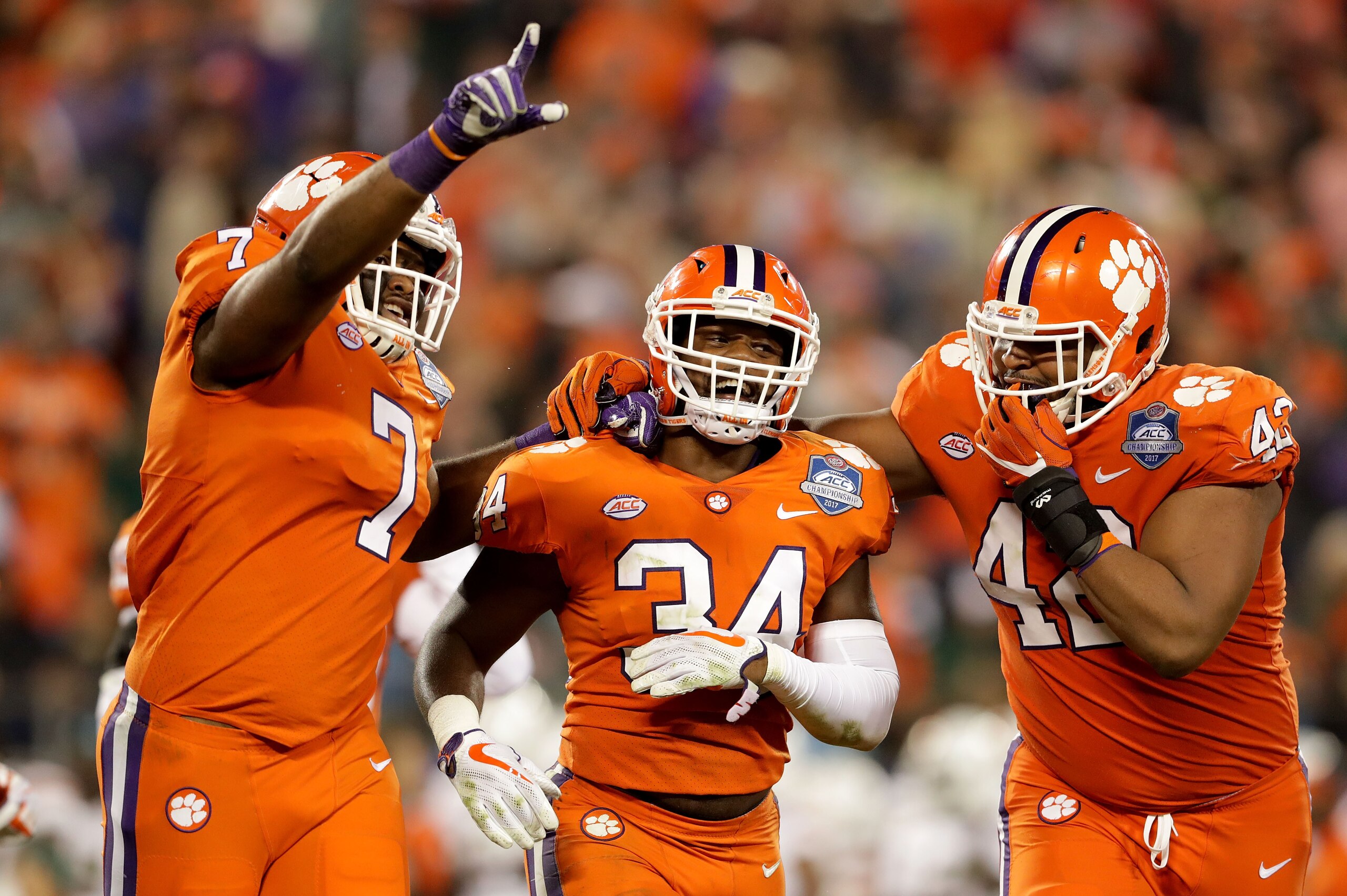 CHARLOTTE, NC - DECEMBER 02: Kendall Joseph #34 celebrates with teammates Austin Bryant #7 and Christian Wilkins #42 of the Clemson Tigers after an interception against the Miami Hurricanes in third quarter during the ACC Football Championship at Bank of CHARLOTTE, NC - DECEMBER 02: Kendall Joseph #34 celebrates with teammates Austin Bryant #7 and Christian Wilkins #42 of the Clemson Tigers after an interception against the Miami Hurricanes in third quarter during the ACC Football Championship at Bank of