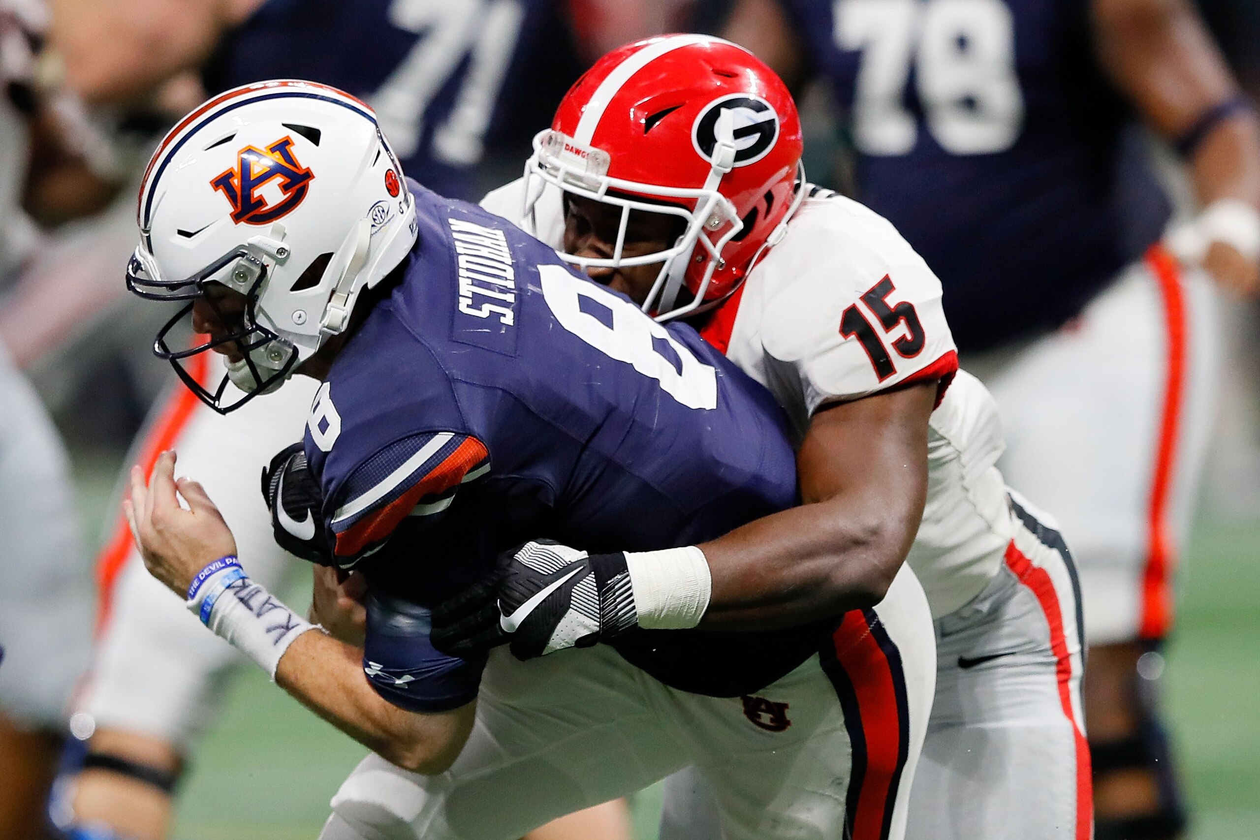 ATLANTA, GA - DECEMBER 02: Jarrett Stidham #8 of the Auburn Tigers is sacked by D'Andre Walker #15 of the Georgia Bulldogs during the second half in the SEC Championship at Mercedes-Benz Stadium on December 2, 2017 in Atlanta, Georgia. (Photo by Kevin C. ATLANTA, GA - DECEMBER 02: Jarrett Stidham #8 of the Auburn Tigers is sacked by D'Andre Walker #15 of the Georgia Bulldogs during the second half in the SEC Championship at Mercedes-Benz Stadium on December 2, 2017 in Atlanta, Georgia. (Photo by Kevin C.