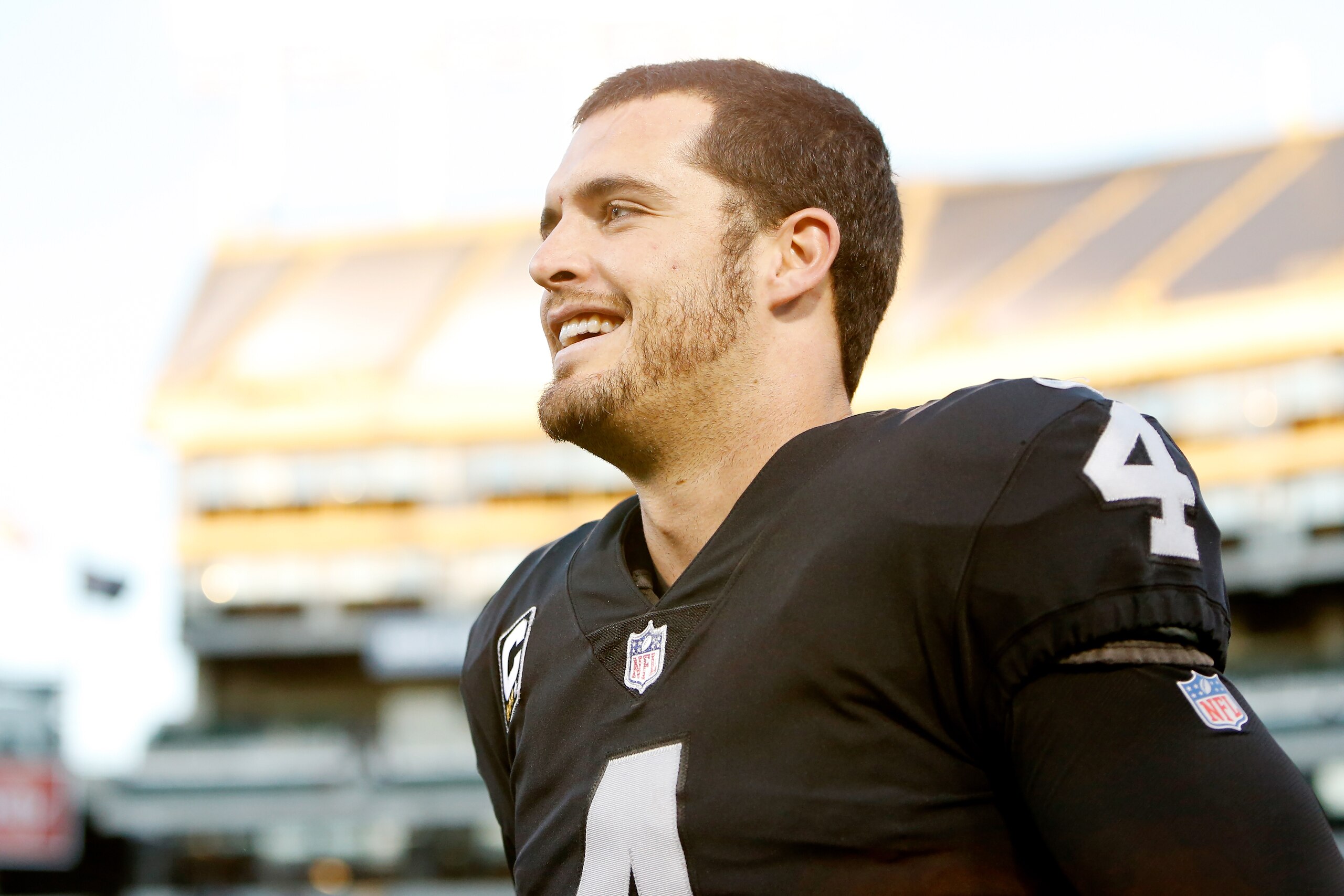 OAKLAND, CA - DECEMBER 03:  Derek Carr #4 of the Oakland Raiders runs off the field after defeating the New York Giants 24-17 in their NFL game at Oakland-Alameda County Coliseum on December 3, 2017 in Oakland, California.  (Photo by Lachlan Cunningham/Ge