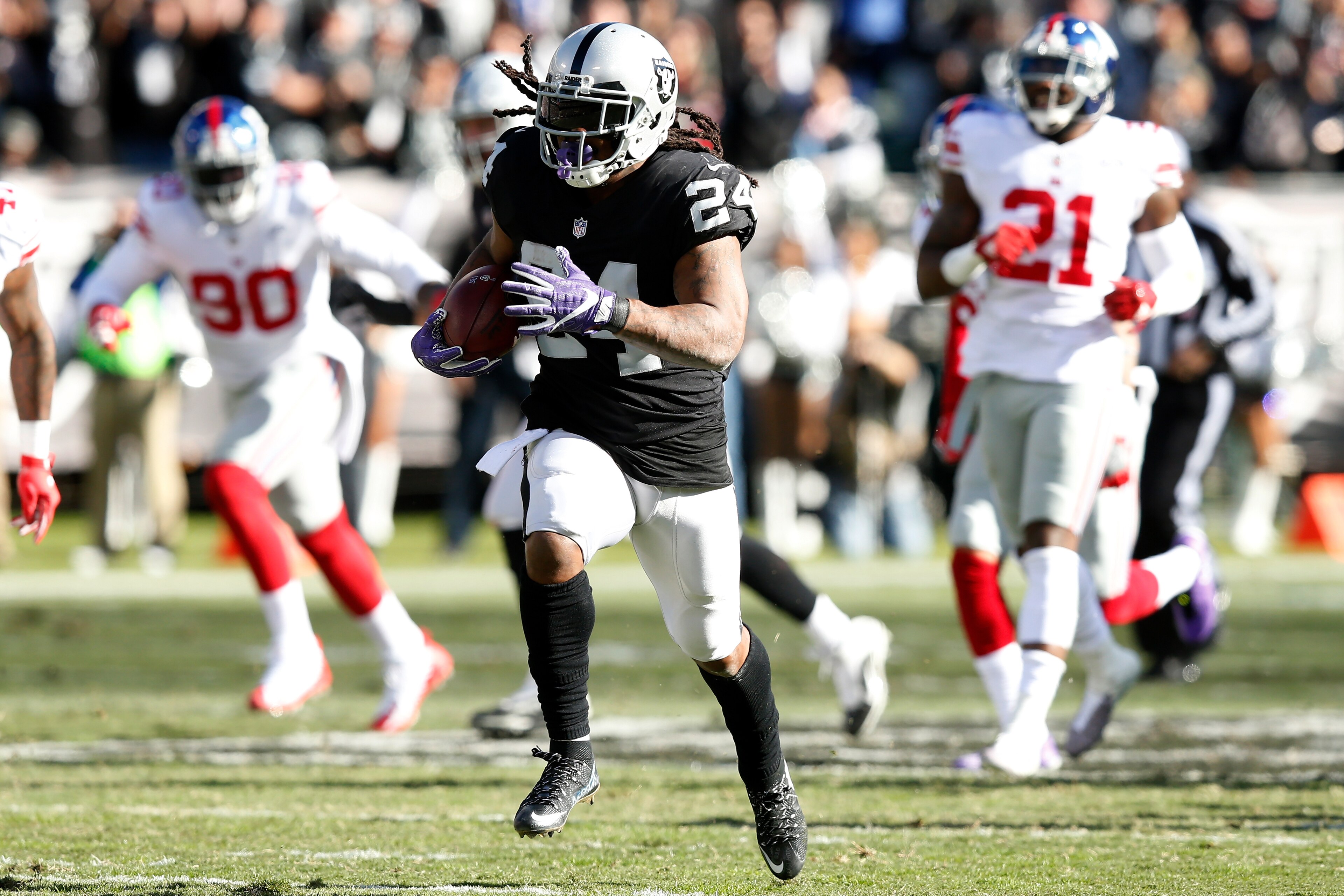 OAKLAND, CA - DECEMBER 03:  Marshawn Lynch #24 of the Oakland Raiders runs for a 51-yard touchdown against the New York Giants during their NFL game at Oakland-Alameda County Coliseum on December 3, 2017 in Oakland, California.  (Photo by Lachlan Cunningh