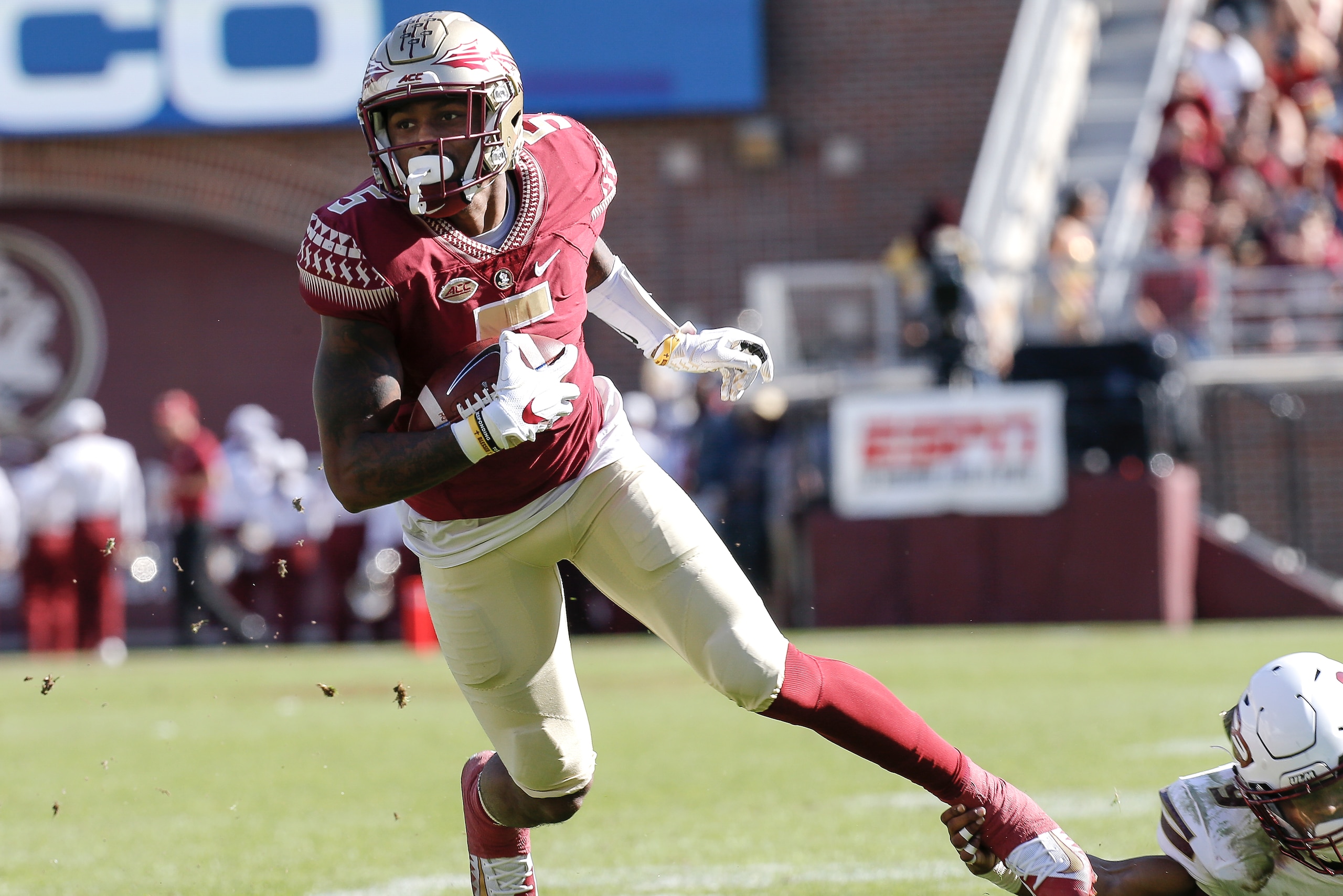 TALLAHASSEE, FL - DECEMBER 2: Wide Receiver Ermon Lane #5 of the Florida State Seminoles is shoe stringed tackled by Cornerback Marcus Hubbard #9 of the Louisiana Monroe Warhawks at Doak Campbell Stadium on Bobby Bowden Field on December 2, 2017 in Tallah TALLAHASSEE, FL - DECEMBER 2: Wide Receiver Ermon Lane #5 of the Florida State Seminoles is shoe stringed tackled by Cornerback Marcus Hubbard #9 of the Louisiana Monroe Warhawks at Doak Campbell Stadium on Bobby Bowden Field on December 2, 2017 in Tallah