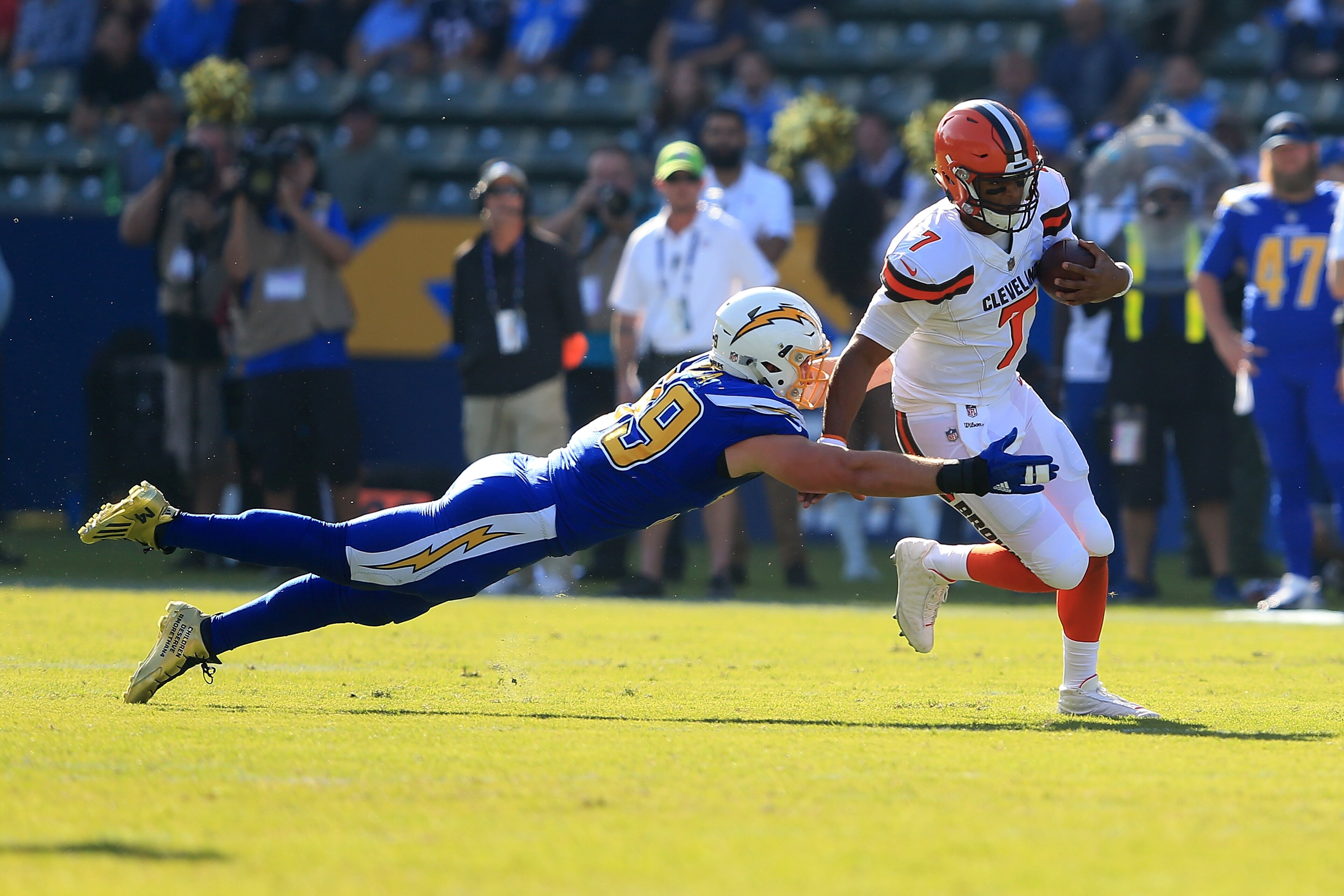 CARSON, CA - DECEMBER 03:  DeShone Kizer #7 of the Cleveland Browns avoids the sack from Joey Bosa #99 of the Los Angeles Chargers during the first half of the game at StubHub Center on December 3, 2017 in Carson, California.  (Photo by Sean M. Haffey/Get