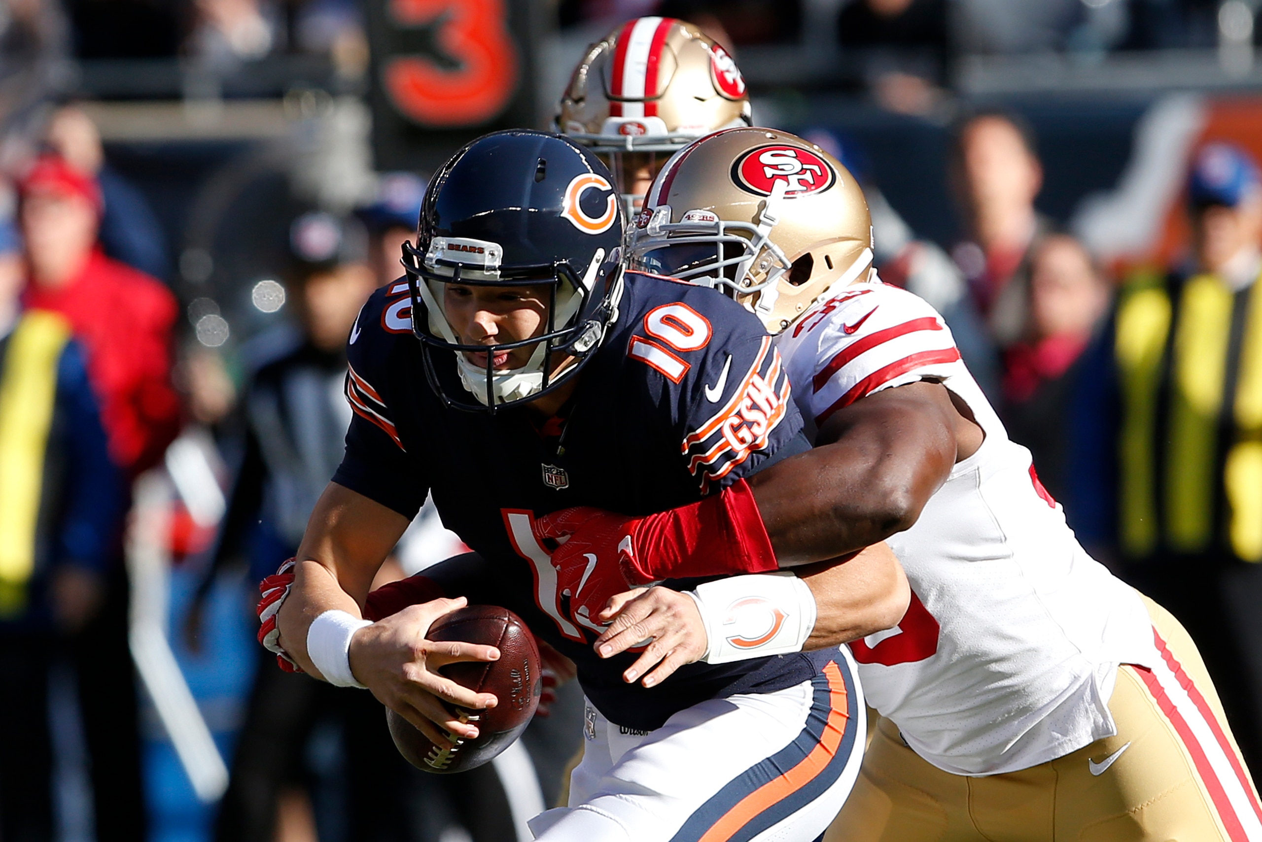 CHICAGO, IL - DECEMBER 03:  Quarterback  Mitchell Trubisky #10 of the Chicago Bears is sacked by  Elvis Dumervil #58 of the San Francisco 49ers in the first quarter at Soldier Field on December 3, 2017 in Chicago, Illinois. The San Francisco 49ers defeate