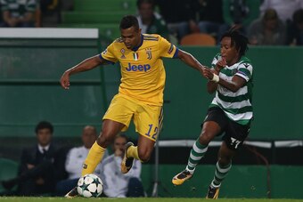LISBON, PORTUGAL - OCTOBER 31: Juventus defender Alex Sandro from Brazil with Sporting CP forward Gelson Martins from Portugal in action during the UEFA Champions League match between Sporting Clube de Portugal and Juventus at Estadio Jose Alvalade on Oct