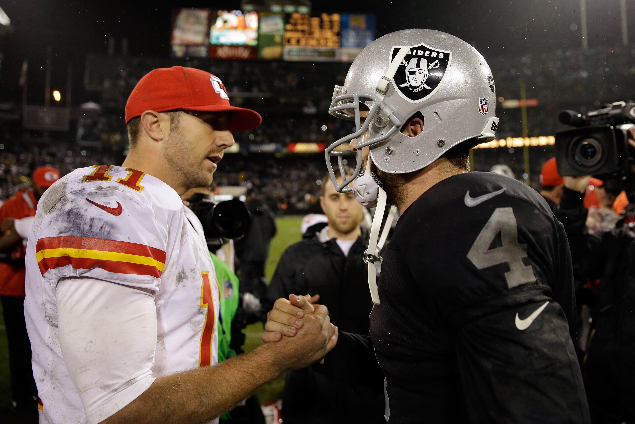 OAKLAND, CA - NOVEMBER 20:  Derek Carr #4 of the Oakland Raiders shakes hands with Alex Smith #11 of the Kansas City Chiefs after the Raiders beat the Chiefs for their first win of the season at O.co Coliseum on November 20, 2014 in Oakland, California.  