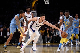 LOS ANGELES, CA - NOVEMBER 15: Ben Simmons #25 of the Philadelphia 76ers steals the ball from Brandon Ingram #14 of the Los Angeles Lakers as teammate Julius Randle #30 reaches for the ball during the second half at Staples Center November 15, 2017, in Lo