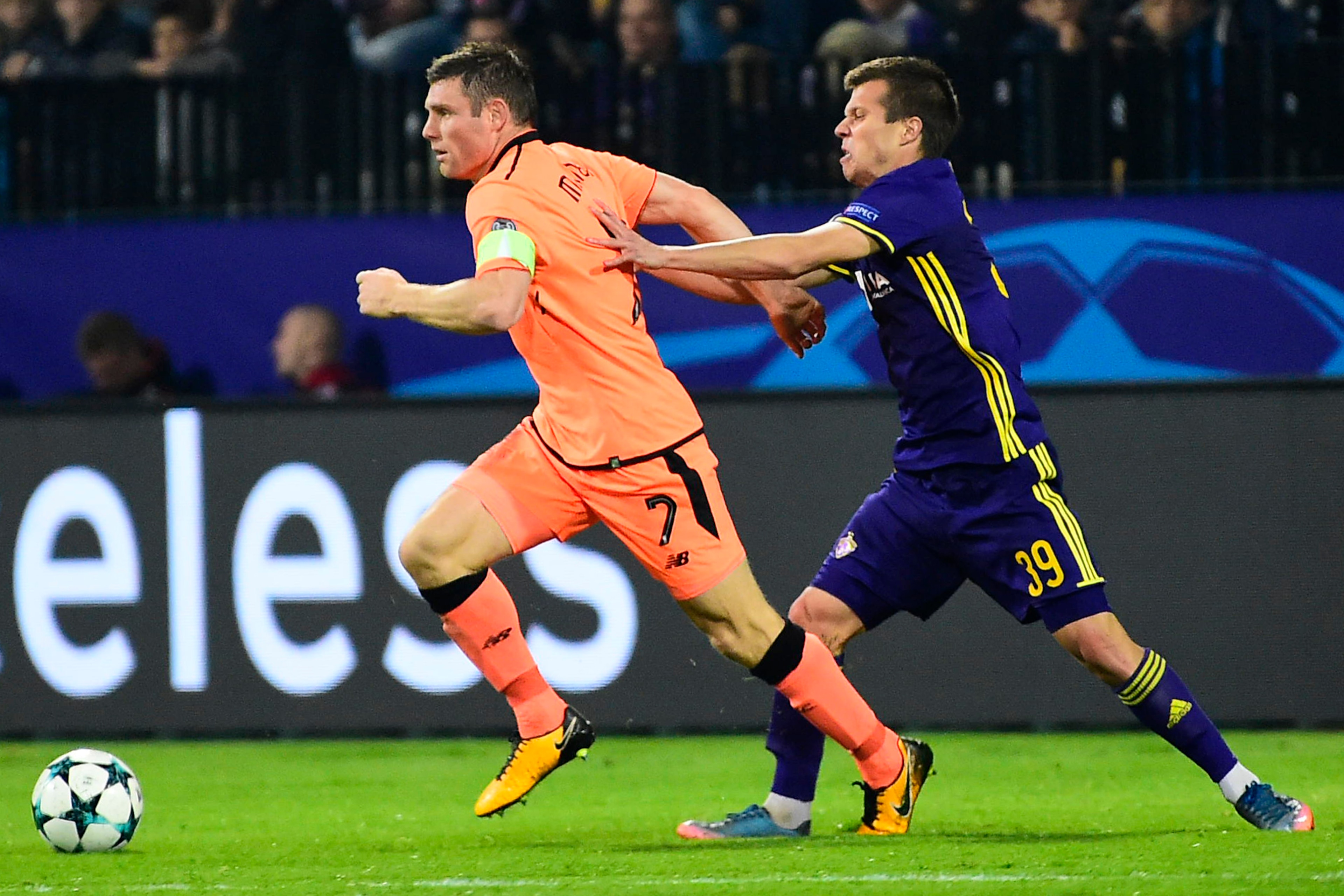 Liverpool's British midfielder James Milner (L) runs with the ball as Maribor's Slovenian midfielder Damjan Bohar (R) tries to tackle him during the UEFA Champions League group E football match between NK Maribor and Liverpool at the Ljudski vrt Stadium, 
