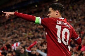 Liverpool's Brazilian midfielder Philippe Coutinho points to his team-mates after scoring their second goal during the UEFA Champions League Group E football match between Liverpool and Spartak Moscow at Anfield in Liverpool, north-west England on Decembe