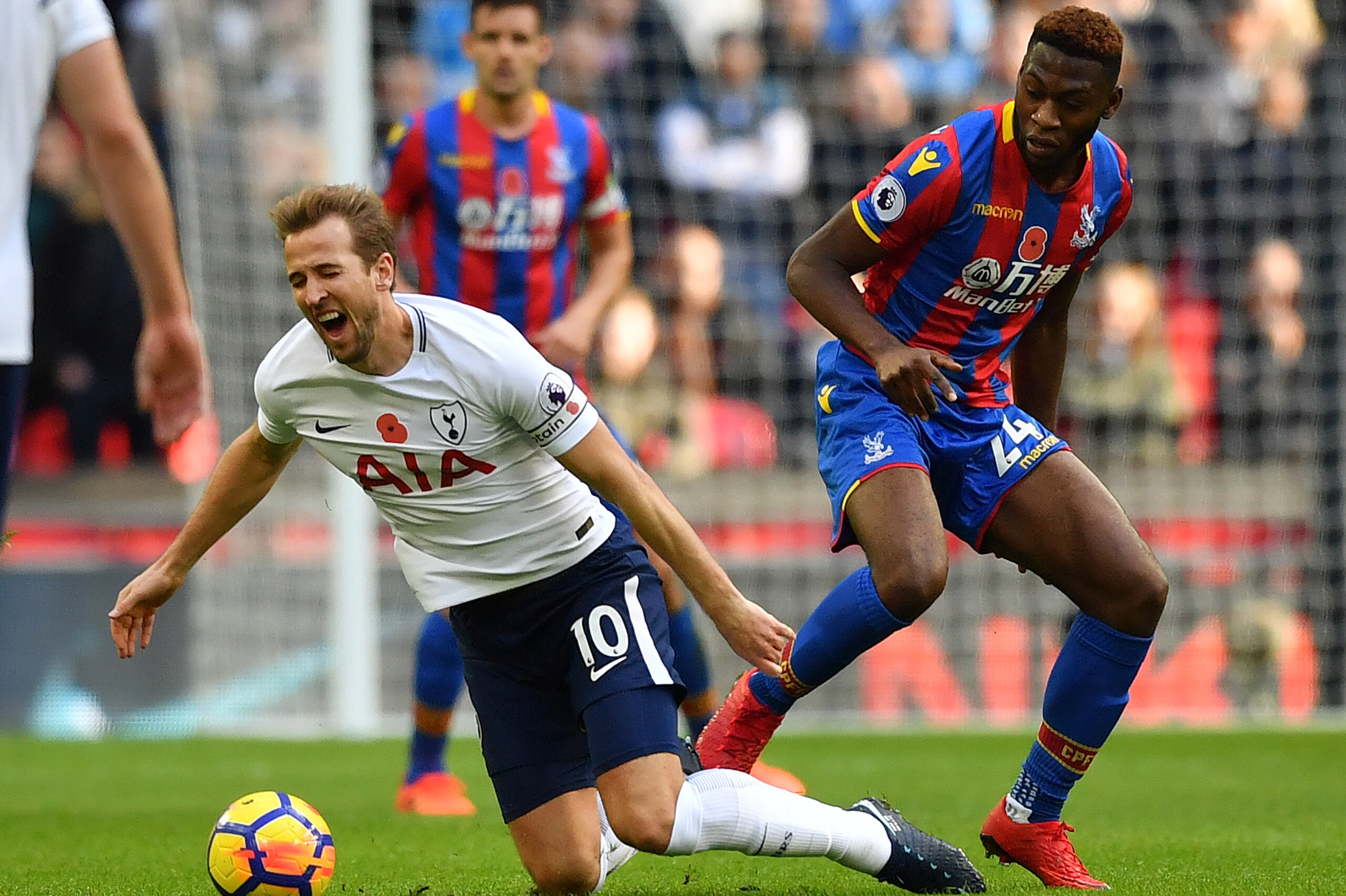 Tottenham Hotspur's English striker Harry Kane (L) reacts after clashing with Crystal Palace's Dutch defender Timothy Fosu-Mensah  during the English Premier League football match between Tottenham Hotspur and Crystal Palace at Wembley Stadium in London, 