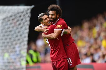 WATFORD, ENGLAND - AUGUST 12:  Mohamed Salah of Liverpool celebrates scoring his sides third goal with Roberto Firmino of Liverpool during the Premier League match between Watford and Liverpool at Vicarage Road on August 12, 2017 in Watford, England.  (Ph
