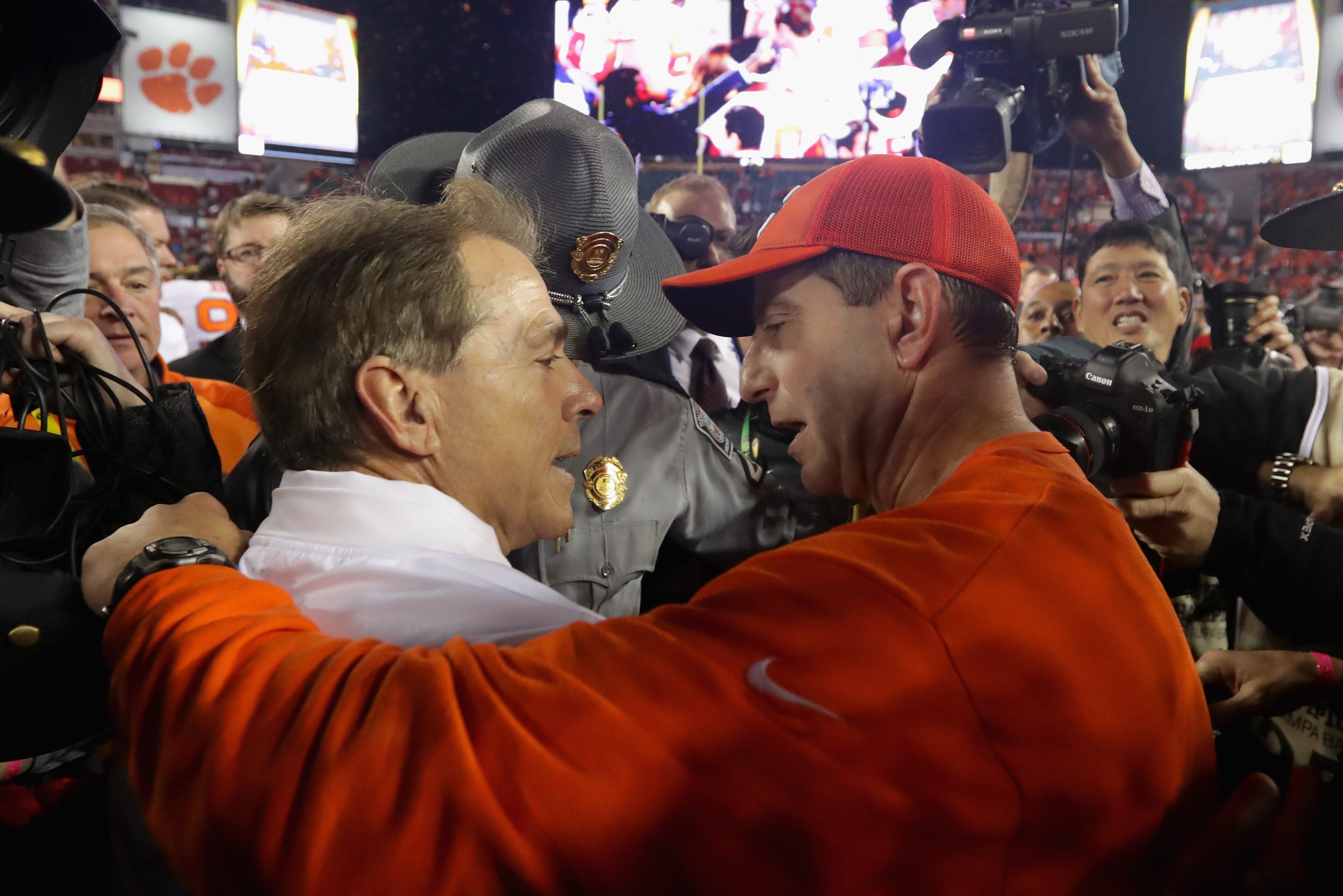 TAMPA, FL - JANUARY 09:  Head coach Nick Saban of the Alabama Crimson Tide talks with head coach Dabo Swinney of the Clemson Tigers after the Tigers defeated the Crimson Tide 35-31 in the 2017 College Football Playoff National Championship Game at Raymond
