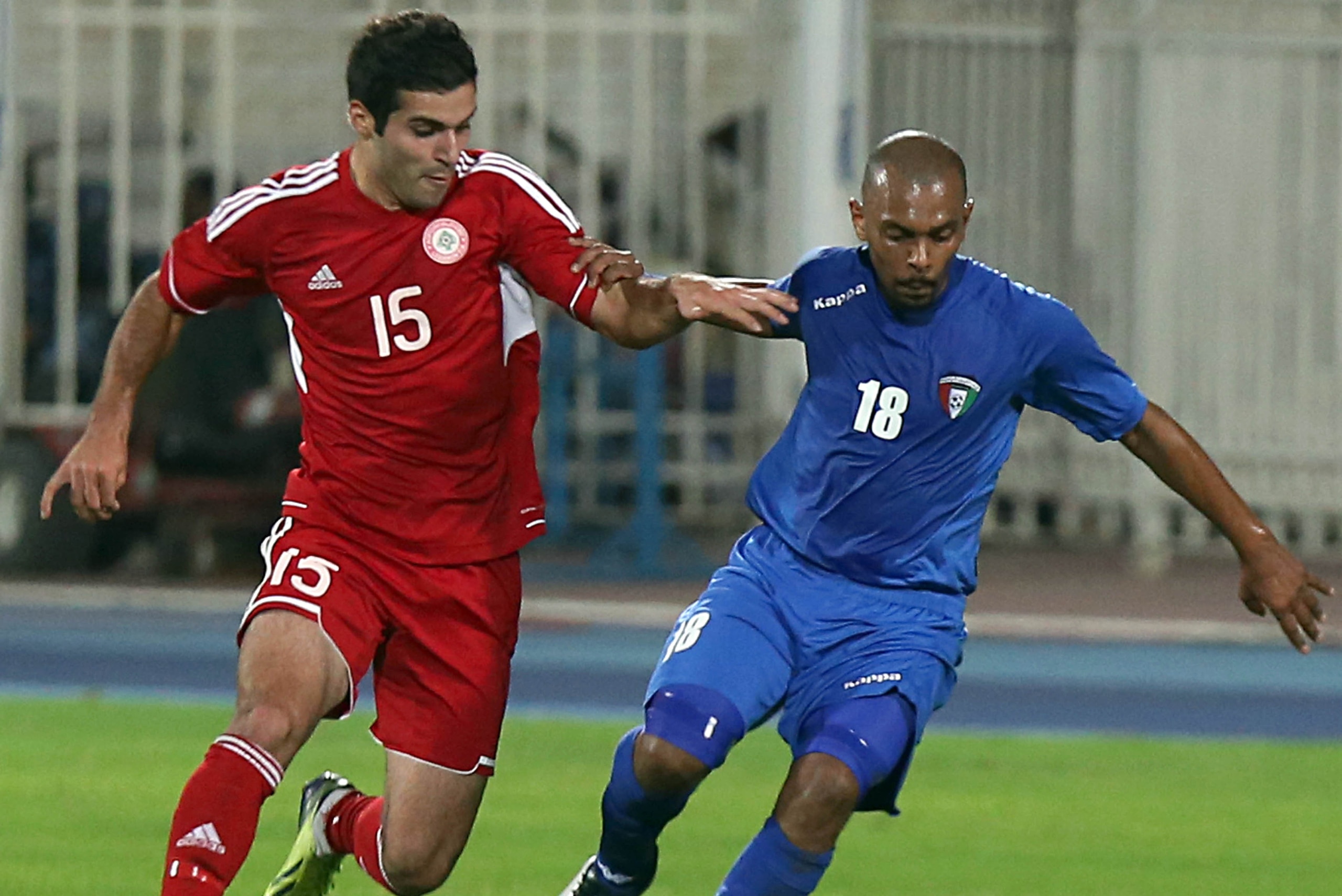 Kuwait's Jarah Al-Ateeqi (R) dribbles past Lebanon's Hassan Ali Saad, Soony, (L) during their AFC Asian cup match in Kuwait city on November 15, 2013. AFP PHOTO/YASSER AL-ZAYYAT        (Photo credit should read YASSER AL-ZAYYAT/AFP/Getty Images)