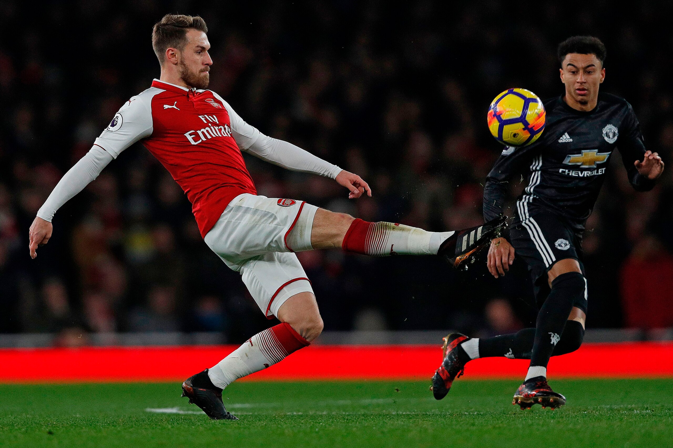 Arsenal's Welsh midfielder Aaron Ramsey (L) vies with Manchester United's English midfielder Jesse Lingard during the English Premier League football match between Arsenal and Manchester United at the Emirates Stadium in London on December 2, 2017.  / AFP