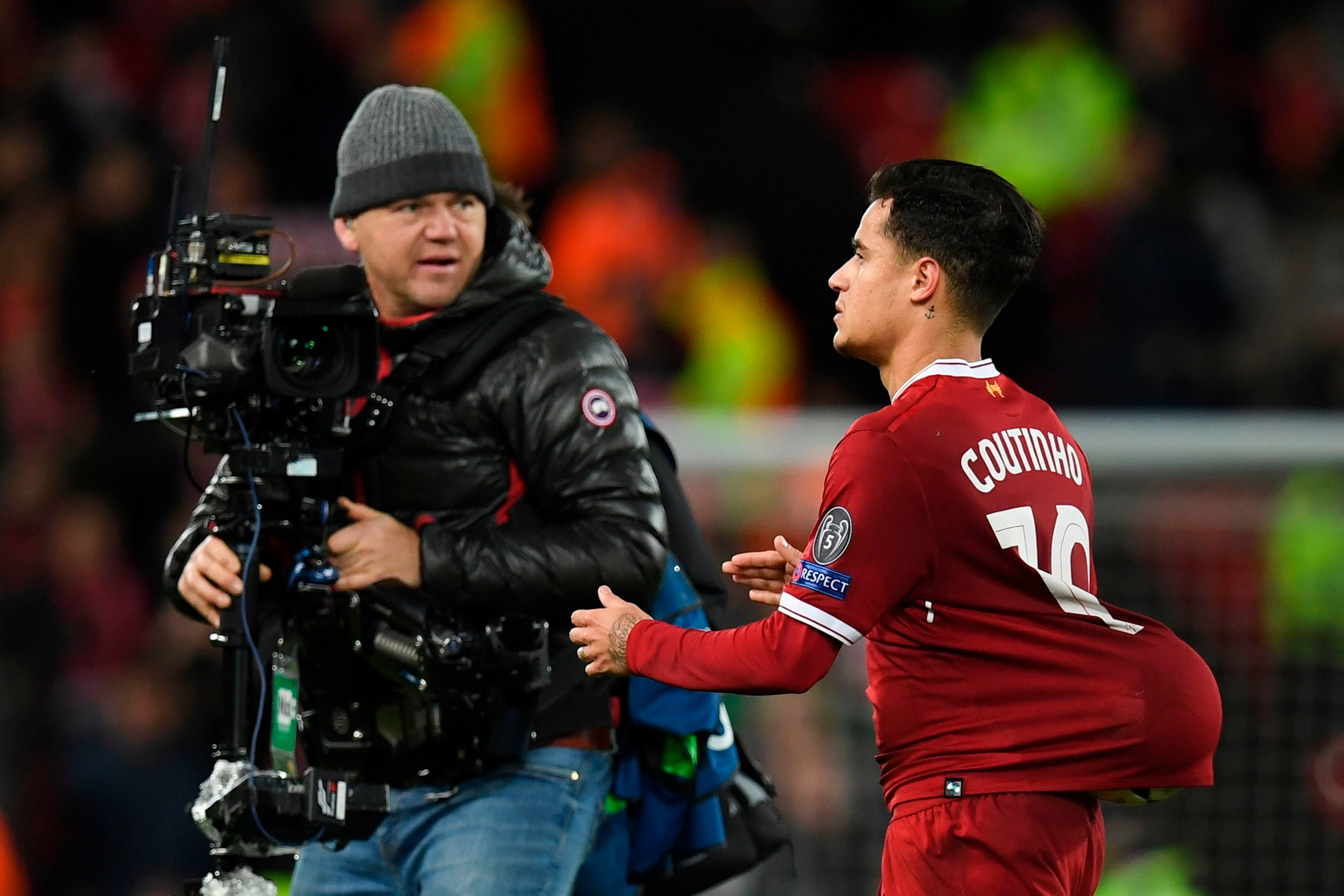 Liverpool's Brazilian midfielder Philippe Coutinho (R) leaves the pitch with the match ball up the back of his jersey at the end of the UEFA Champions League Group E football match between Liverpool and Spartak Moscow at Anfield in Liverpool, north-west E